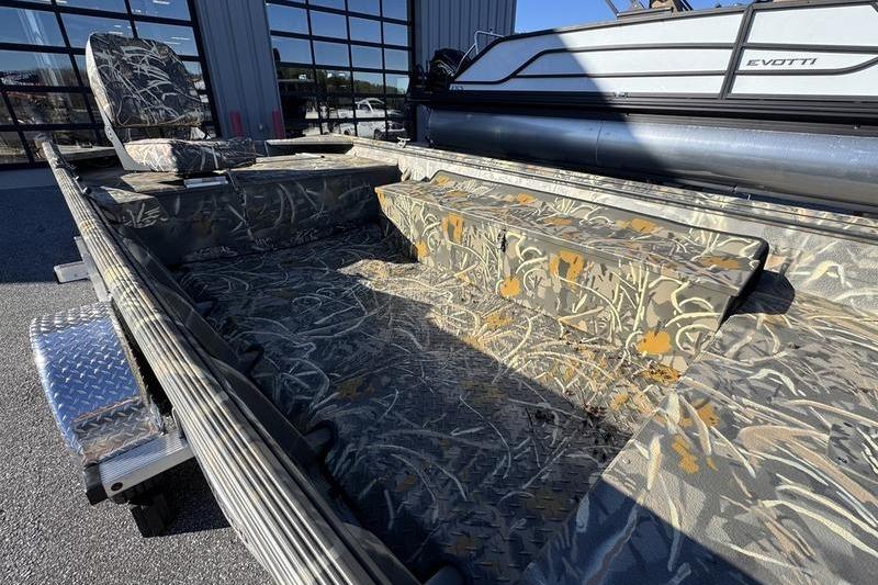 2026 War Eagle 648LDV boat interior with camouflage seating and flooring design.