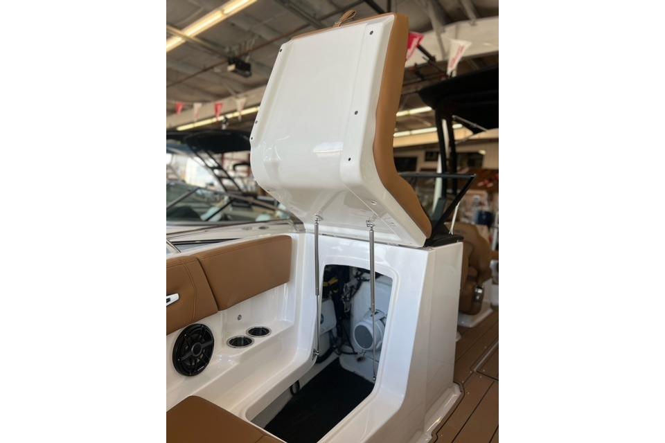 2025 Chaparral 247 SSX boat interior with open storage compartment and seating.
