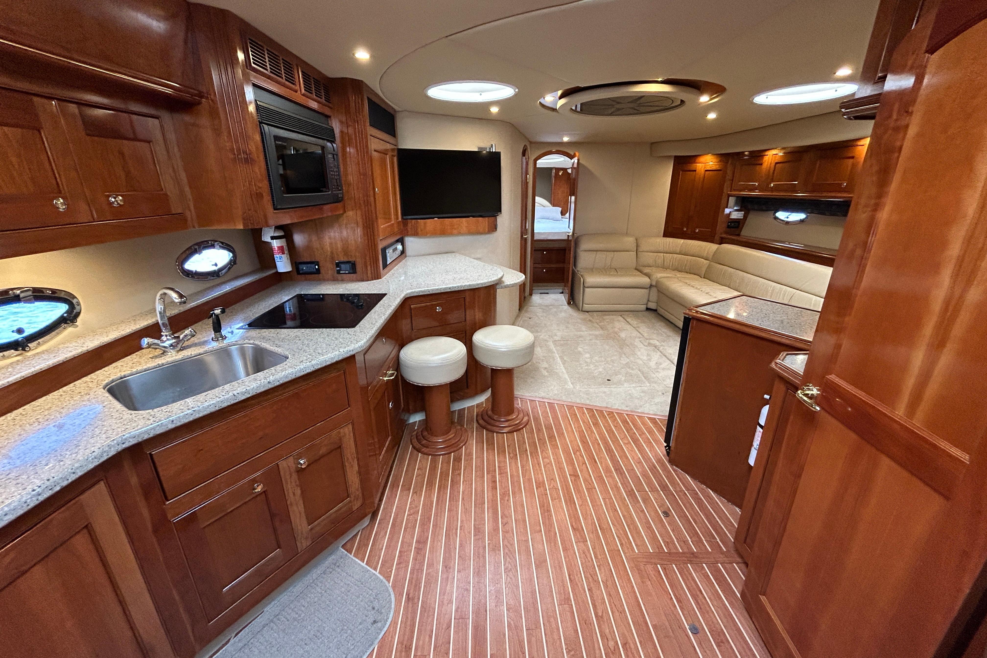 Luxurious 2003 Cruisers Yachts 540 Express interior with kitchen and seating area.