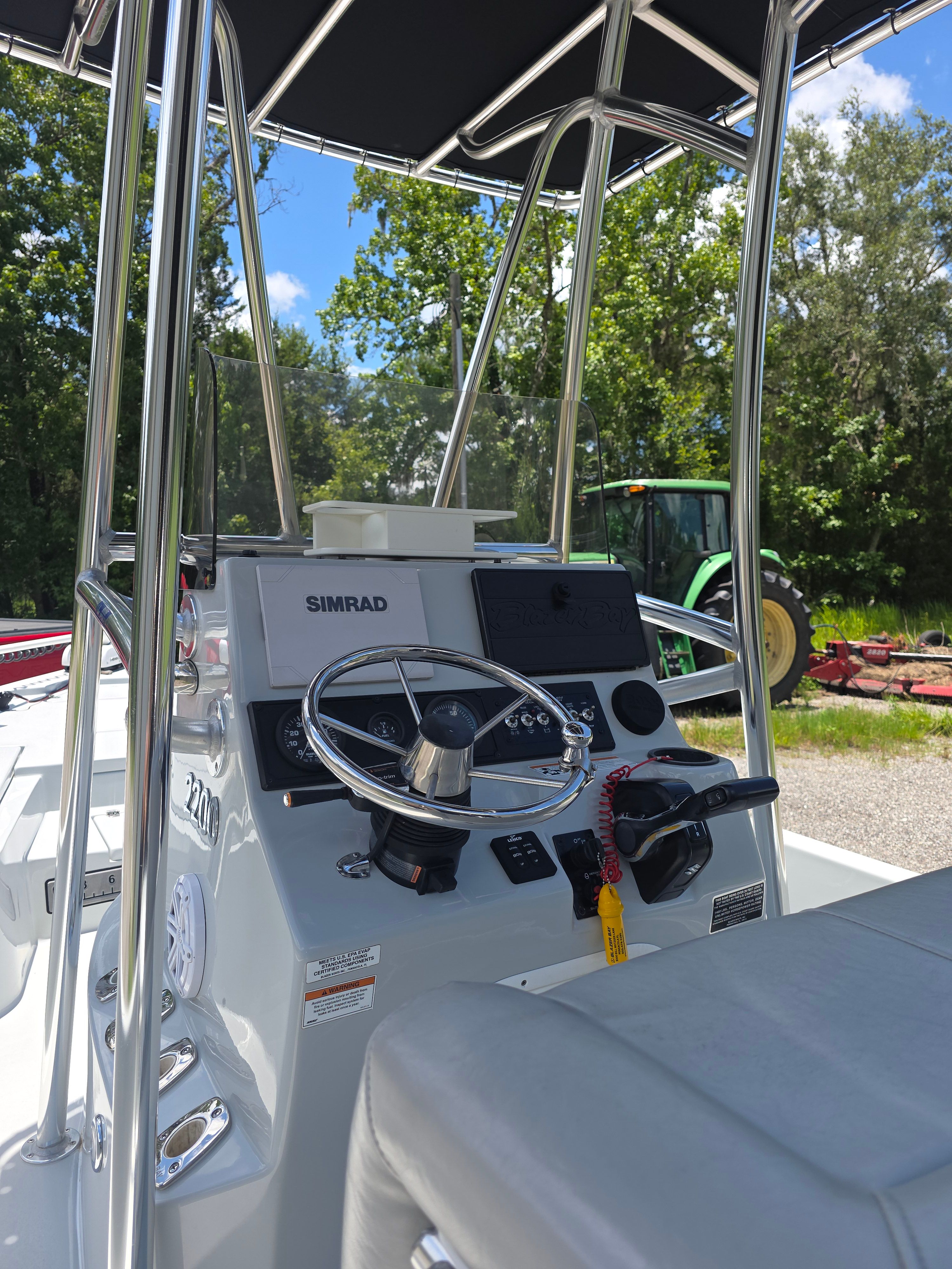 The image shows the helm of a 2019 Blazer Bay 2200 boat with a Simrad system.