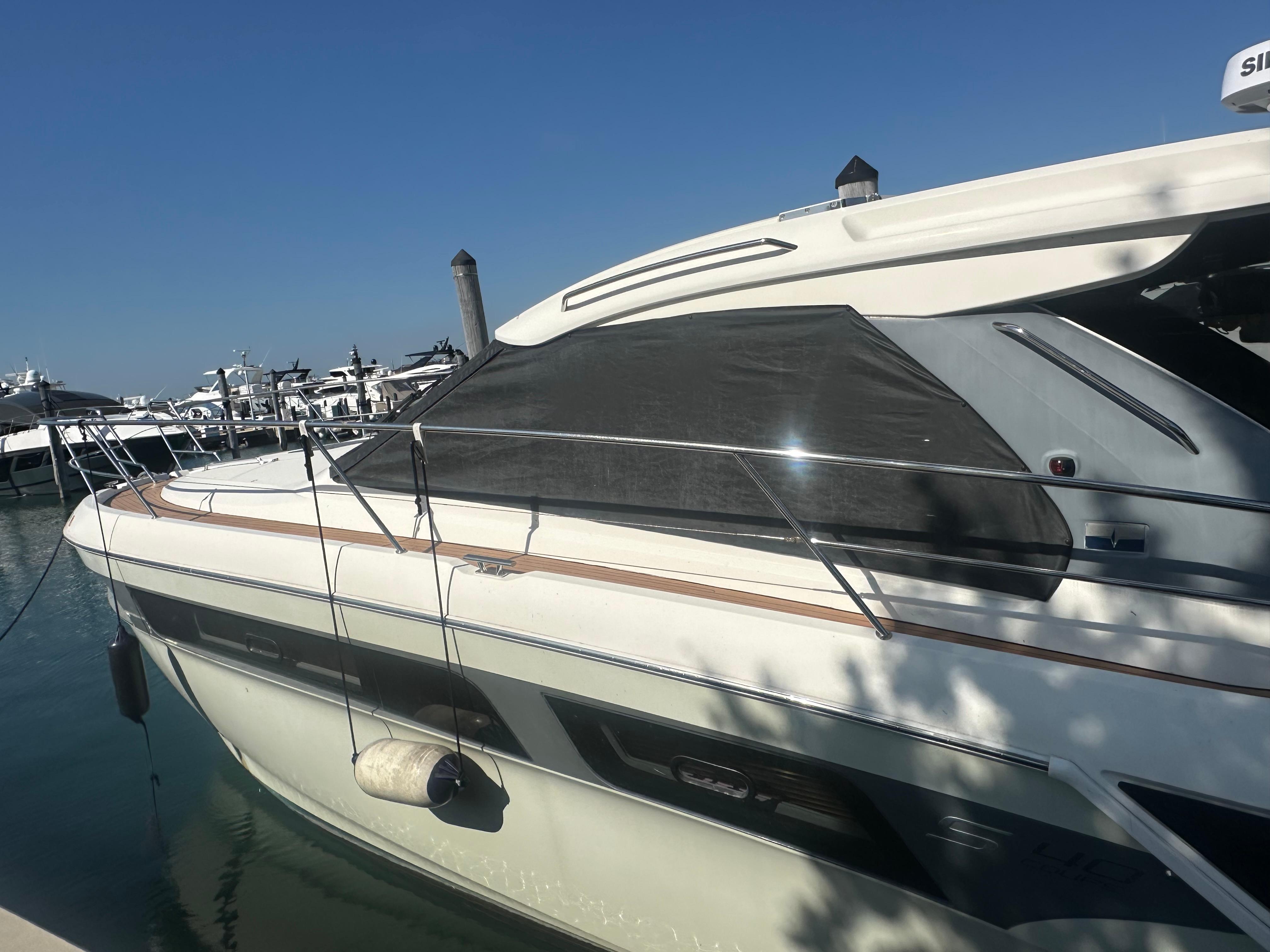 2018 Bavaria S40 Coupe yacht docked at marina under clear blue sky.