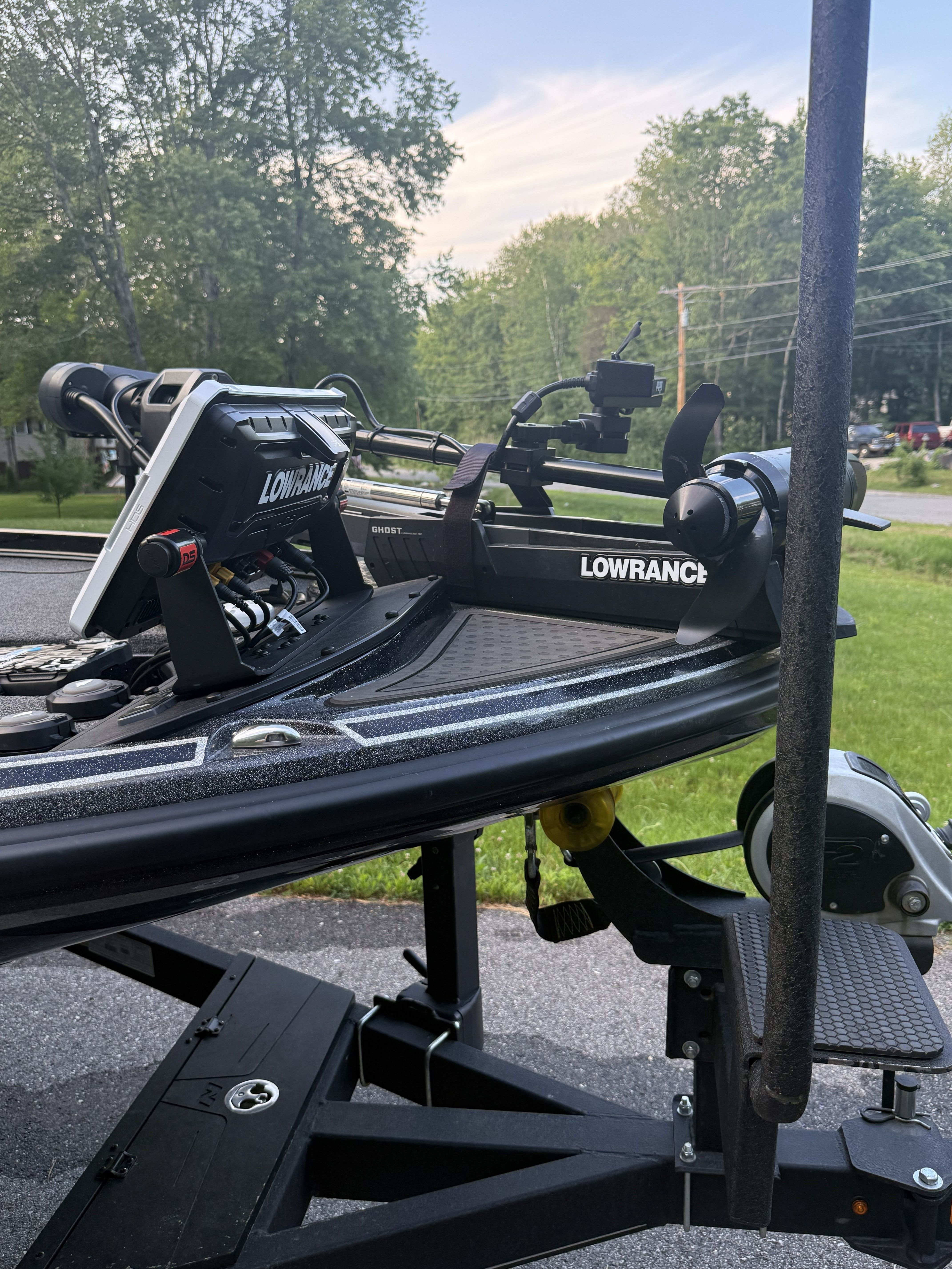 A 2023 Nitro Z21 XL Pro boat with Lowrance equipment on a trailer, surrounded by trees.