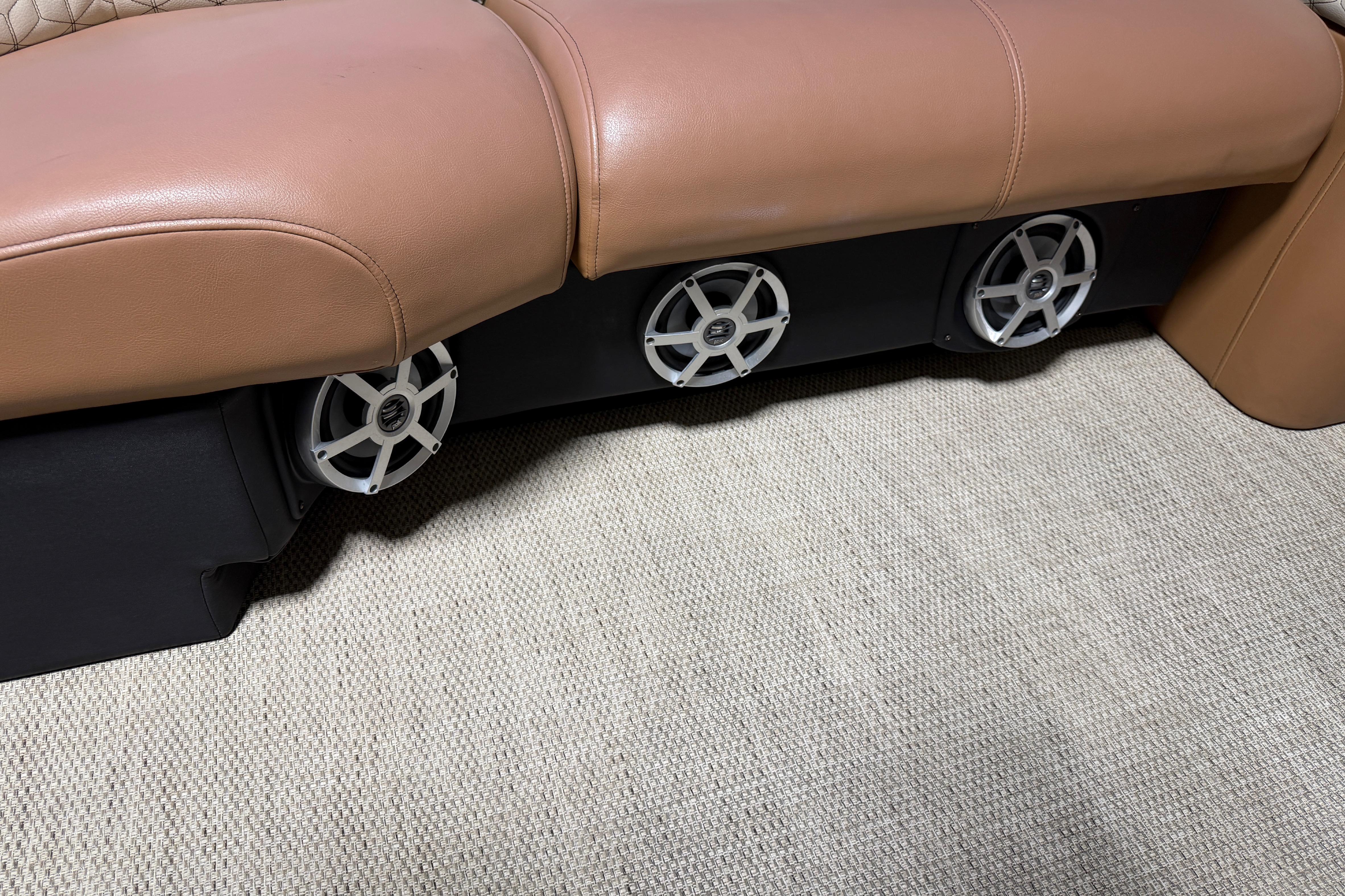 2018 Godfrey Sanpan 2500 ULC boat seating with integrated speakers on carpeted floor.