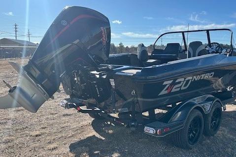 2026 Nitro ZV20 Pro boat with powerful outboard motor, parked on a trailer in sunlight.
