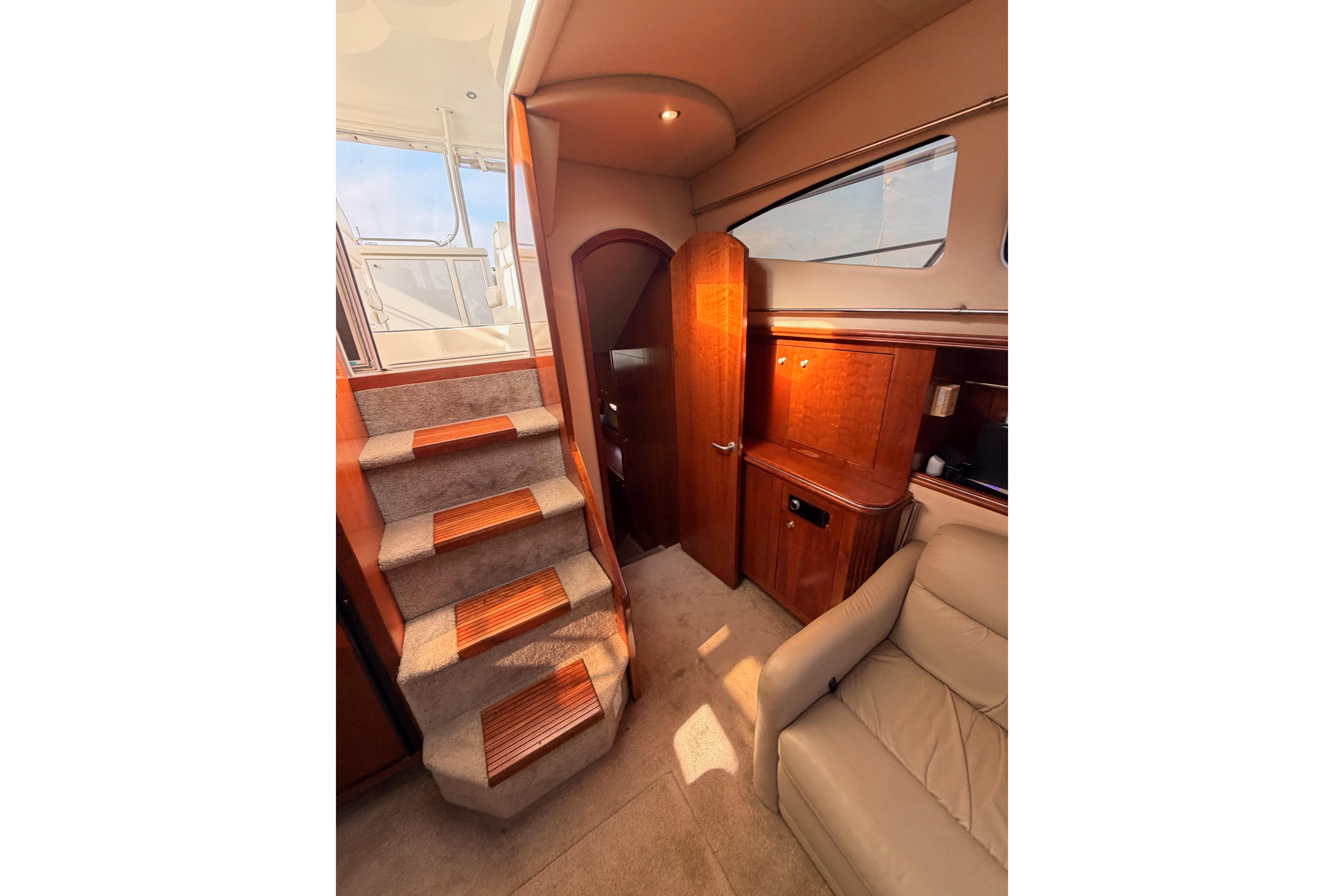Interior of 2005 Cruisers Yachts 405 Express Motoryacht with stairs and seating area.