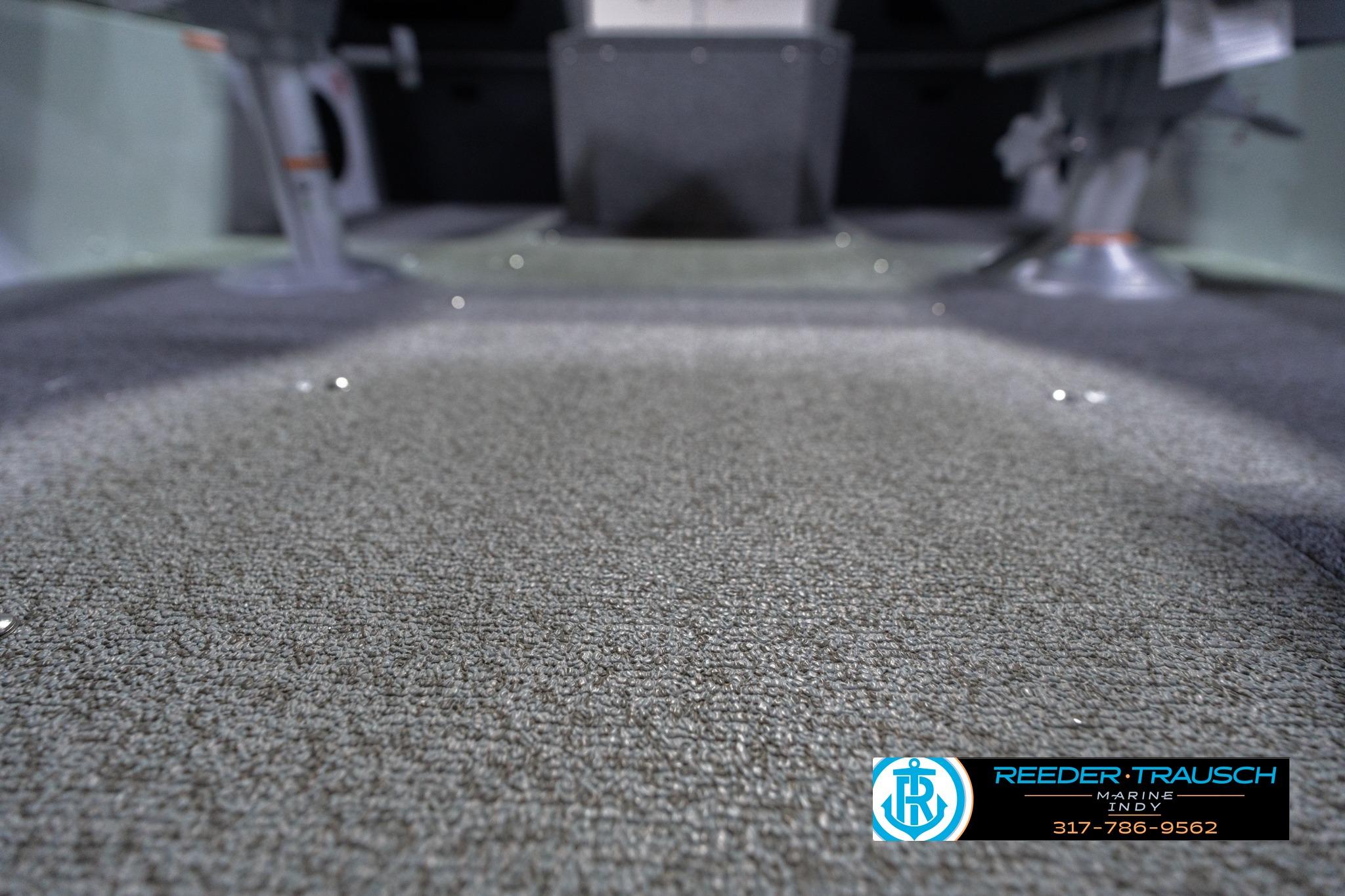 2026 Lund 1700 Explorer Sport interior with carpeted flooring, showcasing marine craftsmanship.