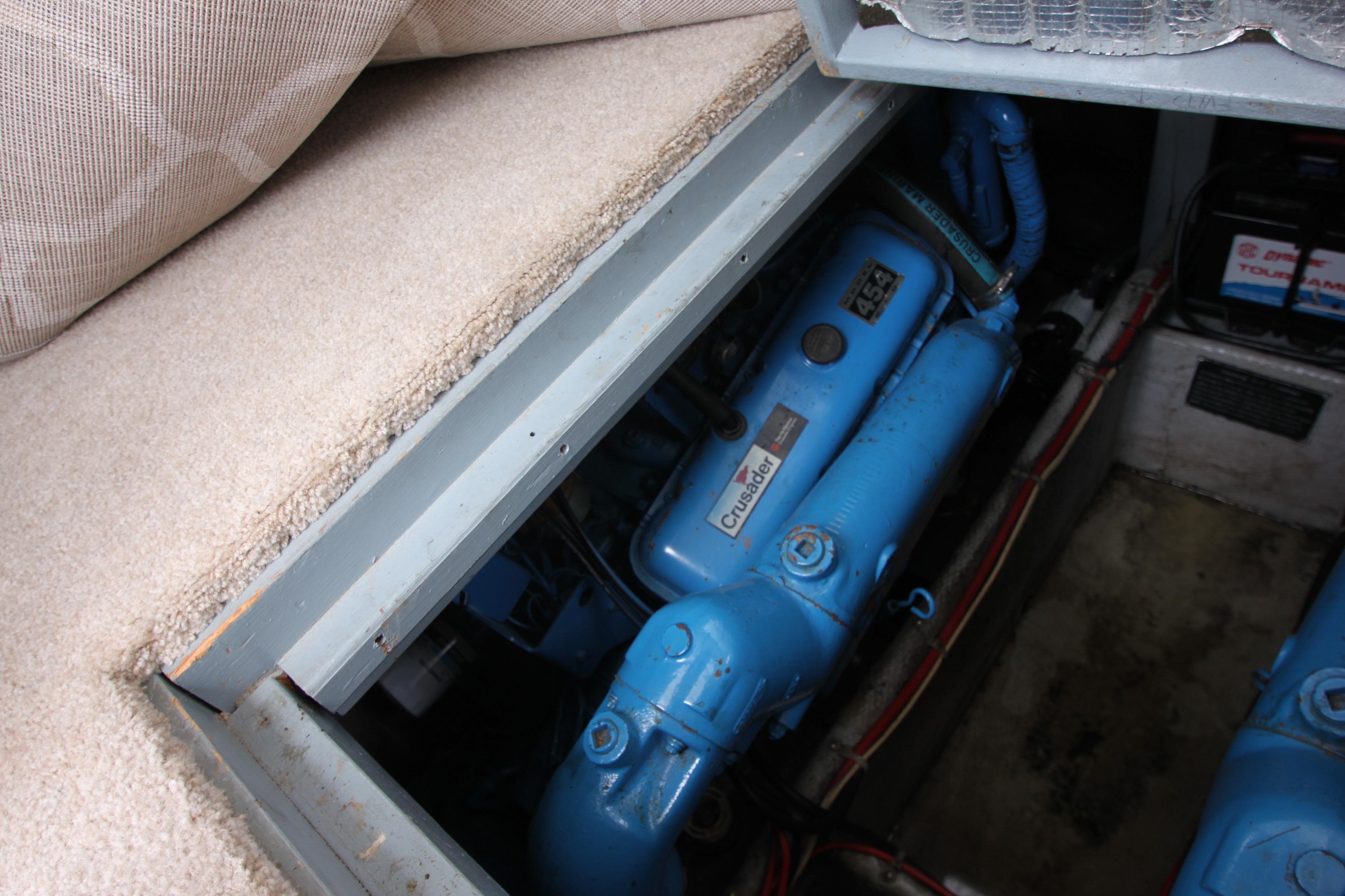 Engine compartment of a 1990 Silverton 34 Convertible boat, featuring a blue engine.
