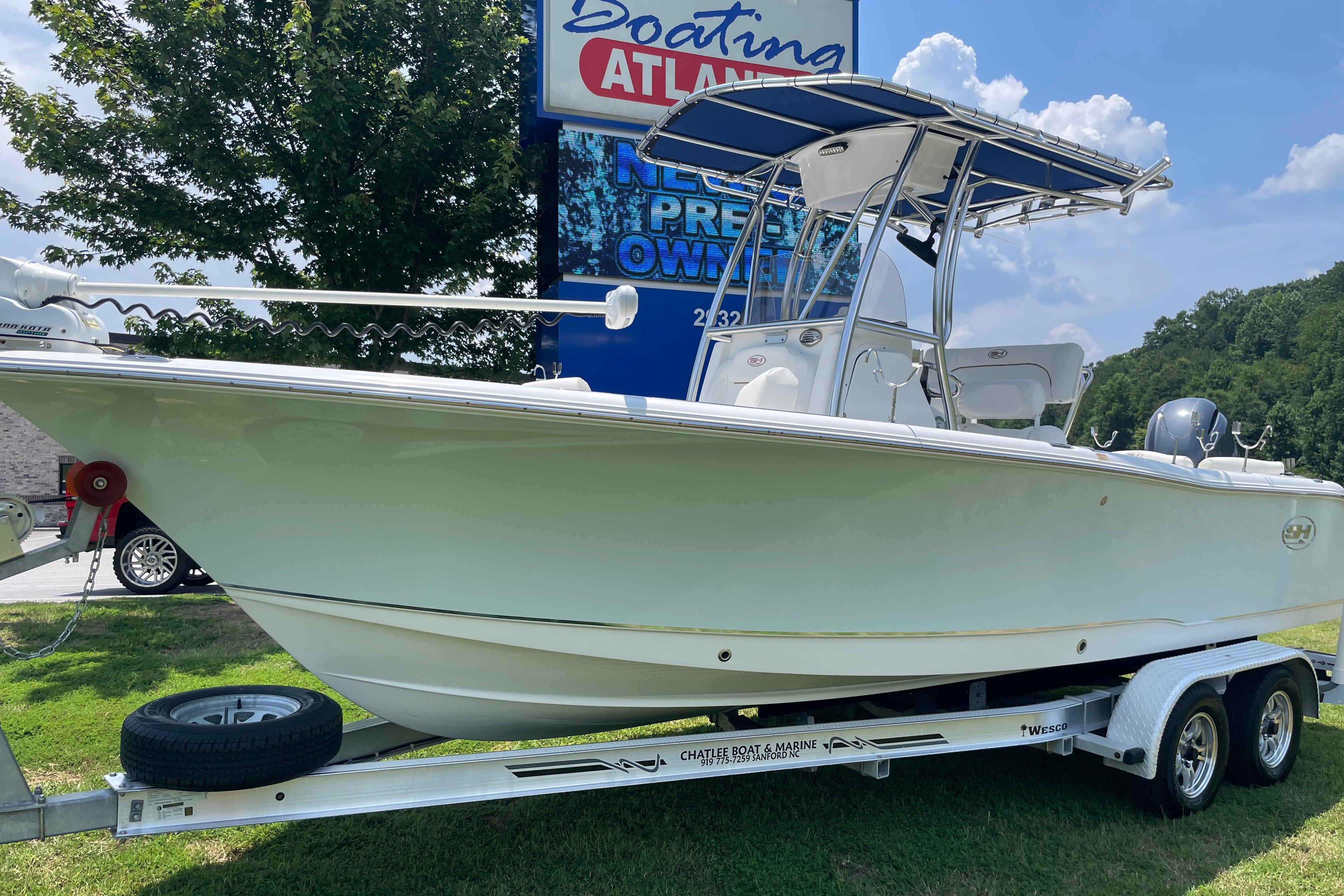 2018 Sea Hunt Ultra 234 boat on trailer, displayed outdoors near Boating Atlanta sign.
