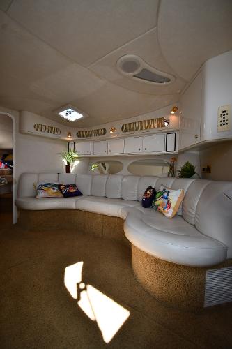 Luxurious interior of 1997 Sea Ray 400 Sundancer yacht with plush seating and elegant decor.