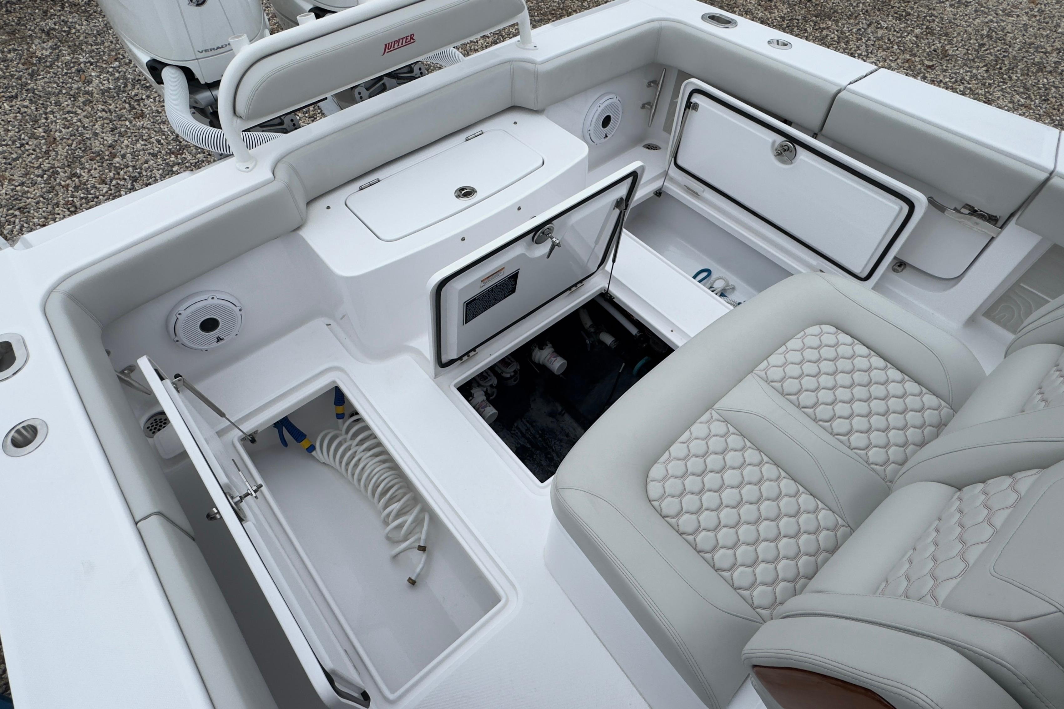 2024 Jupiter 32 FS boat interior with storage compartments and cushioned seating.