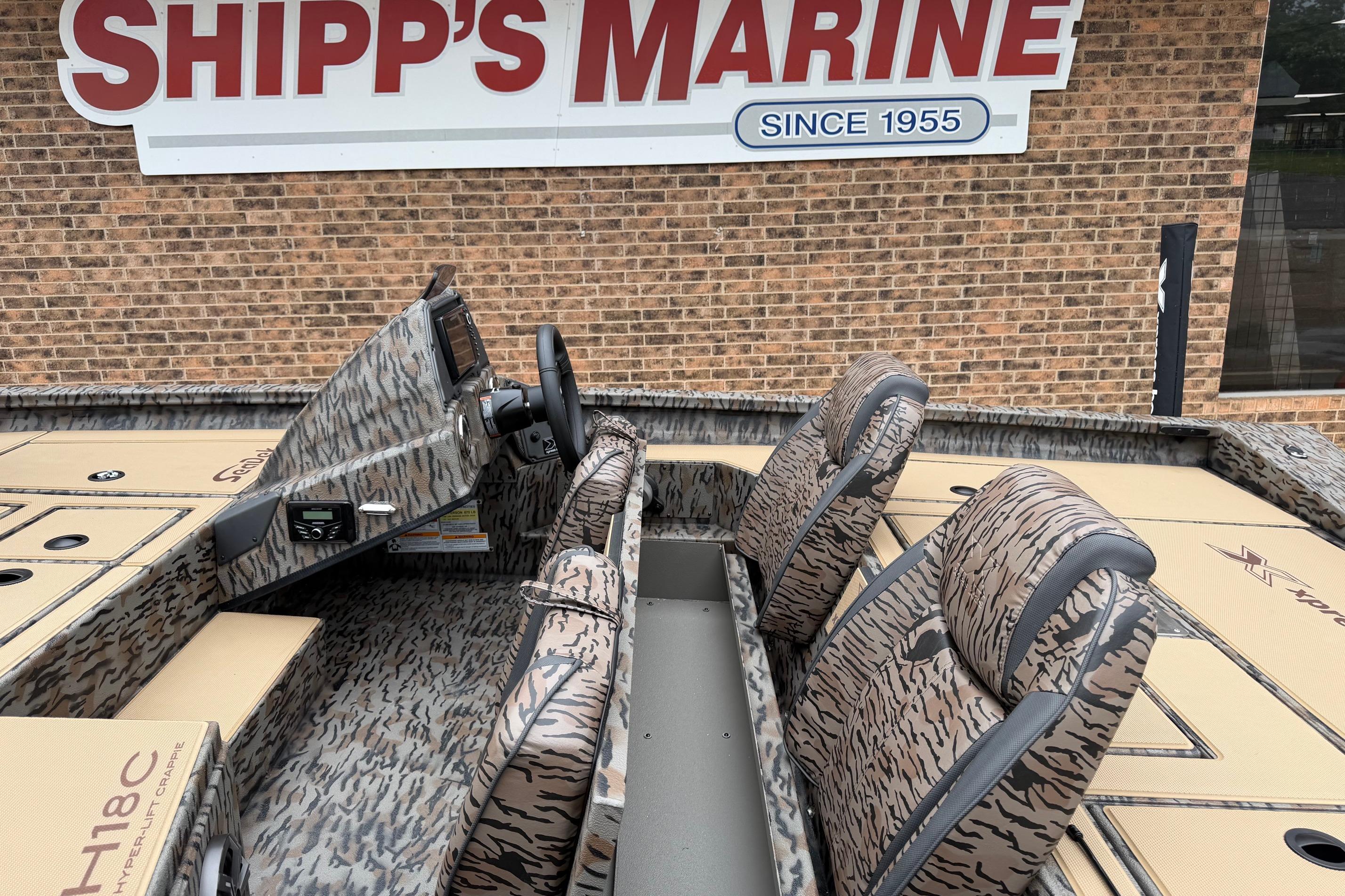 2026 Xpress H18C Crappie boat interior at Shipp's Marine, featuring camo design and seating.