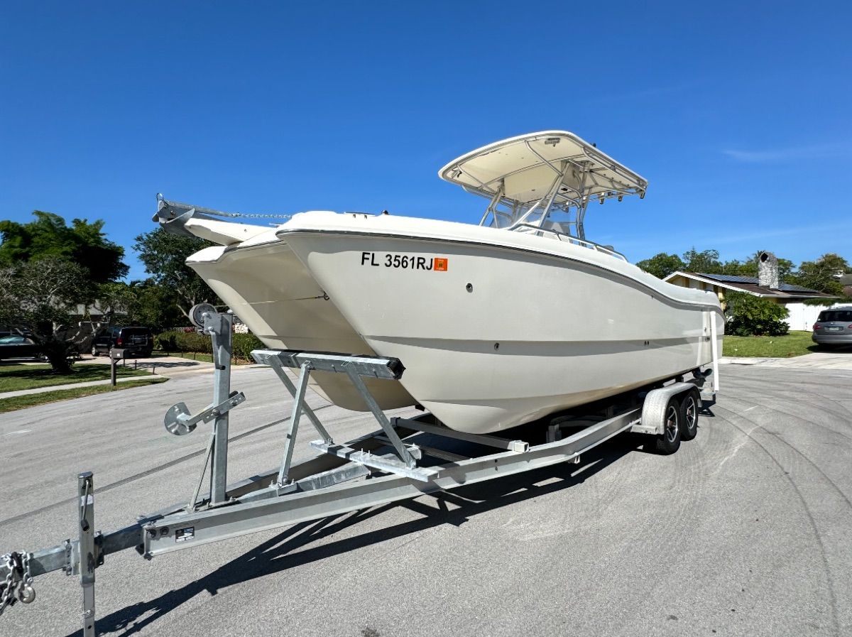 2004 World Cat 270TE boat on trailer, sunny day.