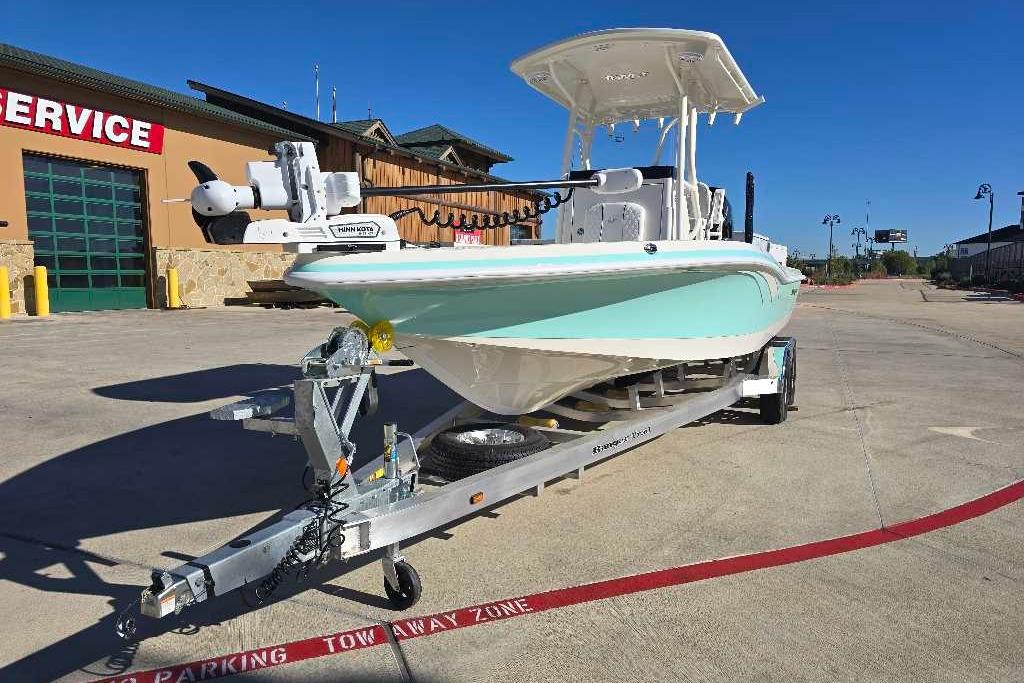 2025 Ranger 2510 Bay boat on trailer outside service center, clear sky background.