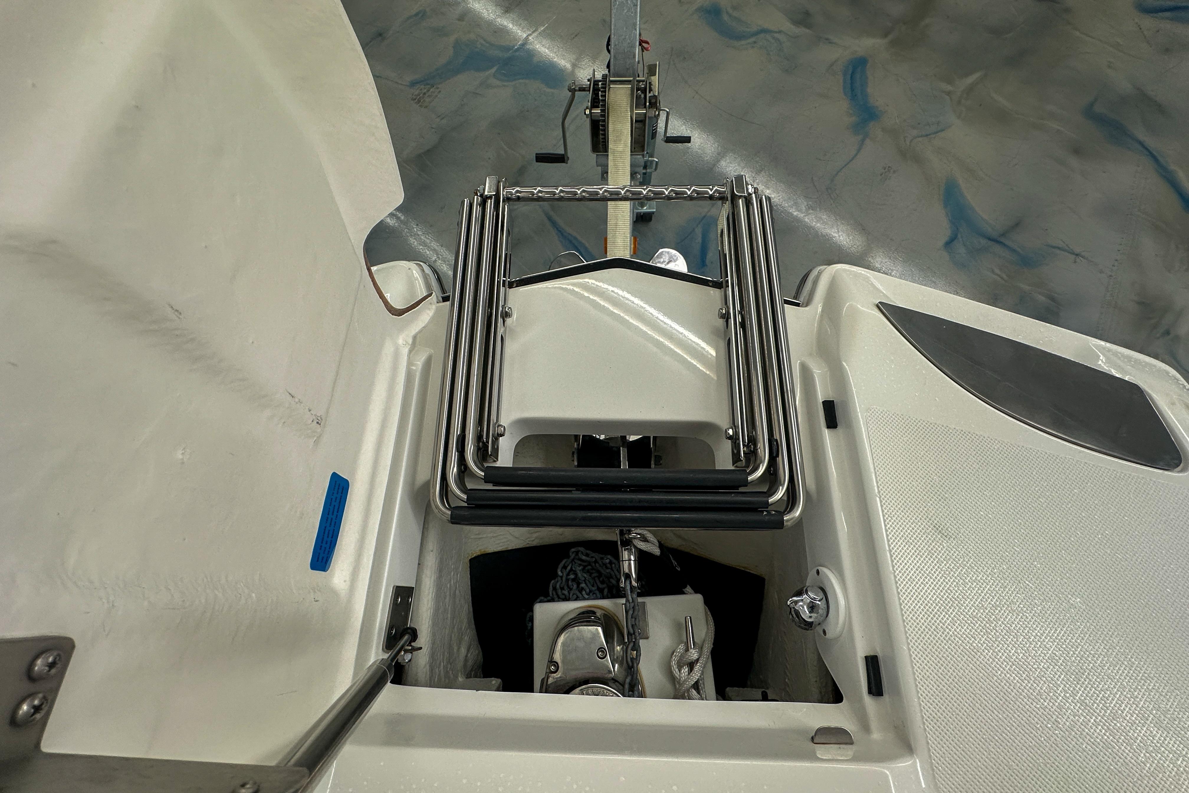 2022 Cobalt 25SC boat anchor compartment with ladder, viewed from above.