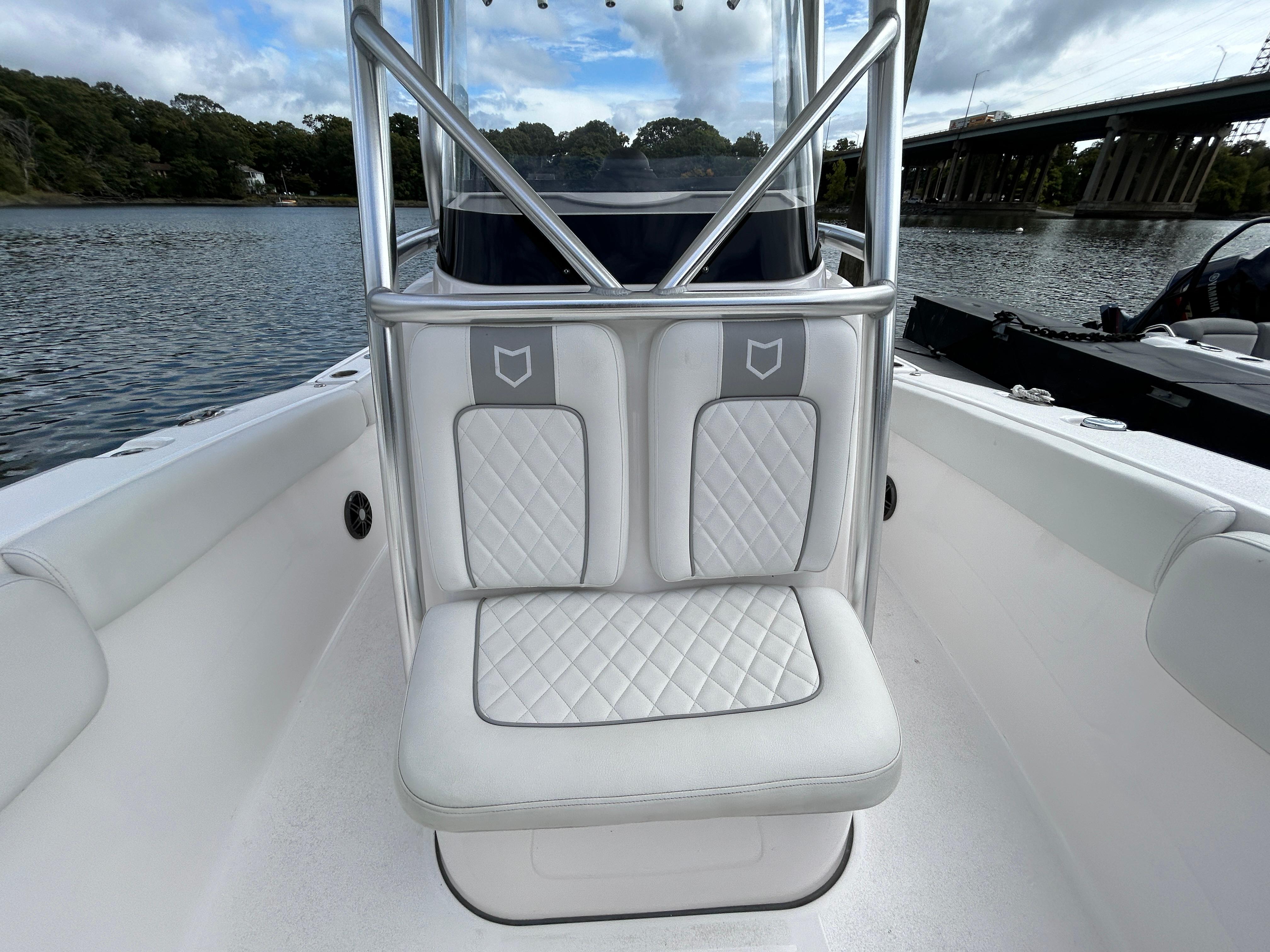 2025 Sea Fox 248 Commander boat interior with cushioned seating on a calm waterway.