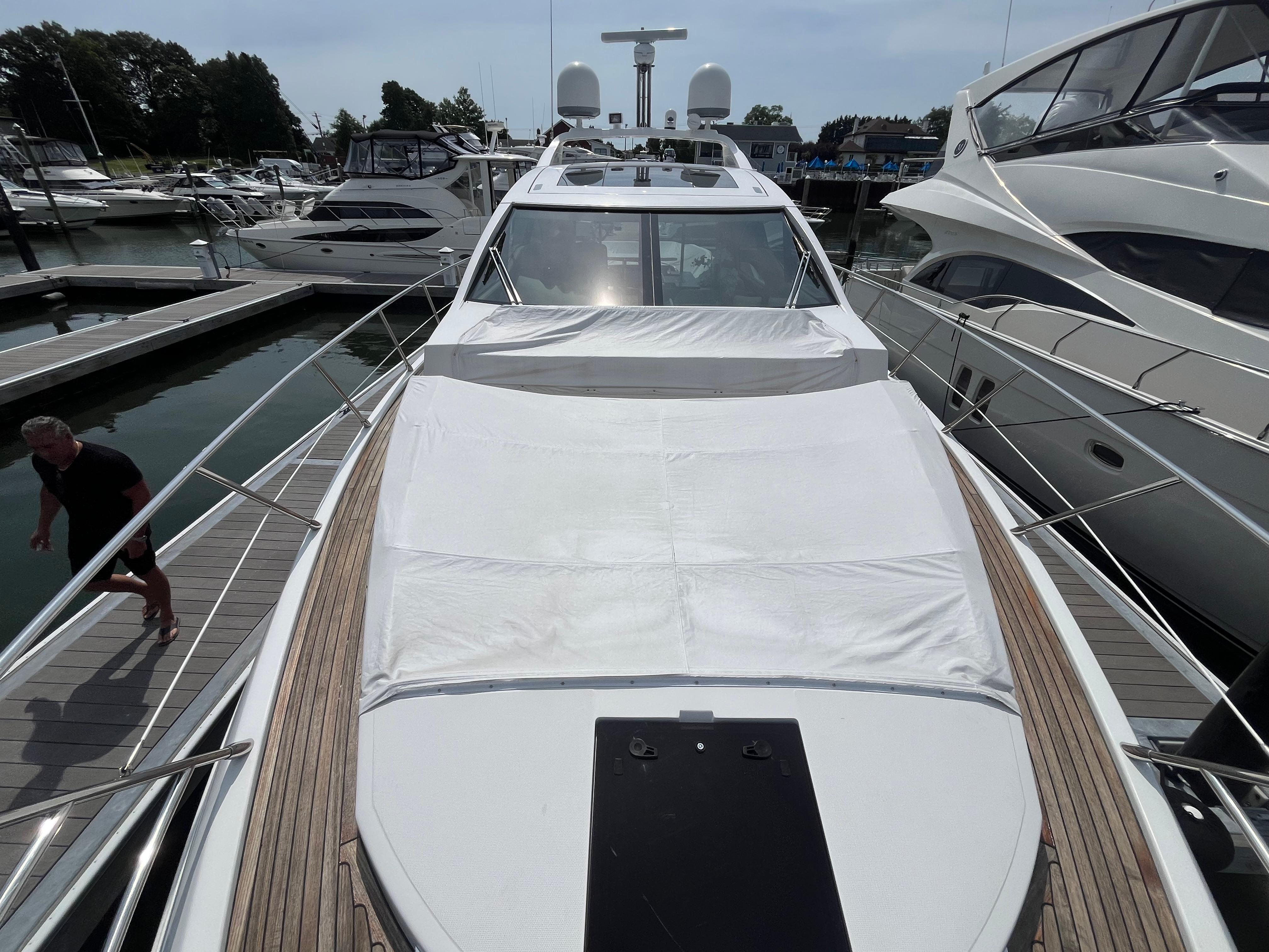 2014 Azimut 55S yacht docked at marina, showcasing sleek design and spacious deck.