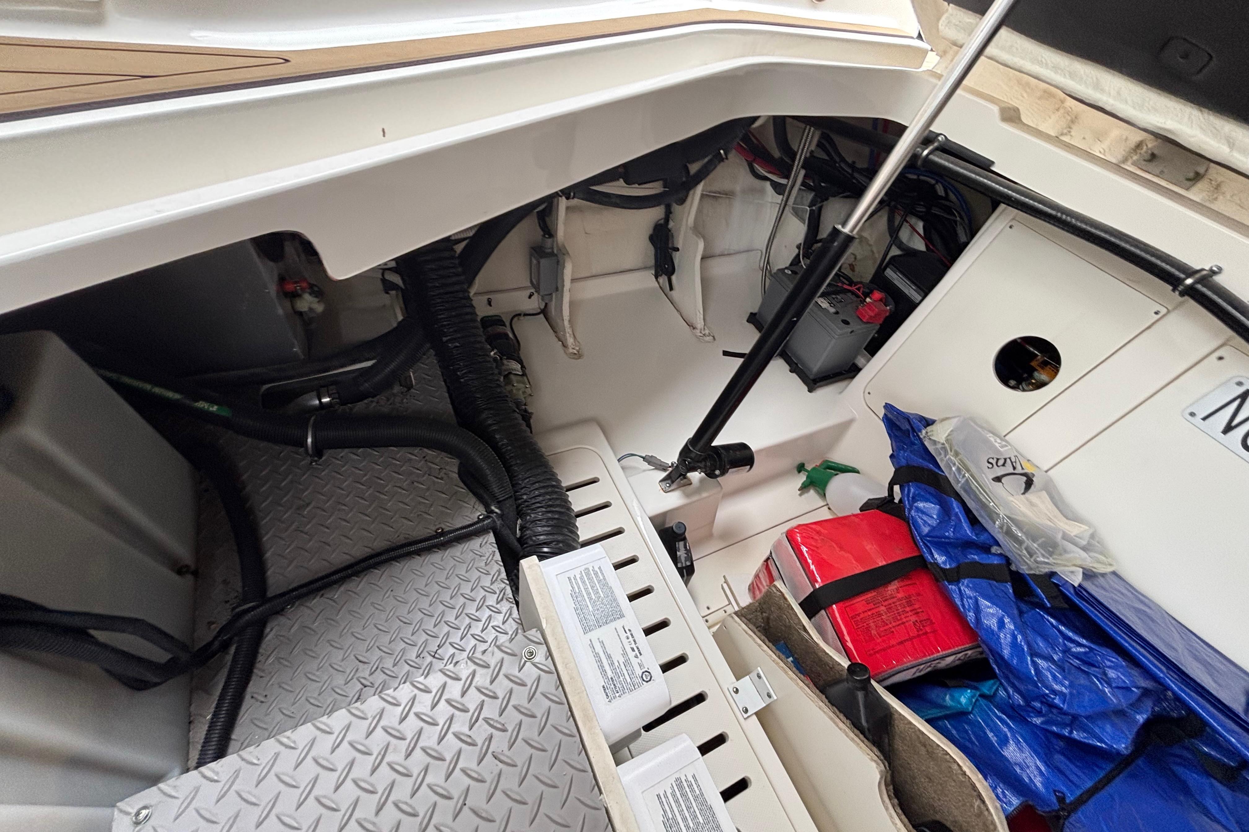 2021 Sea Ray Sundancer 320 Outboard storage compartment with equipment and supplies.