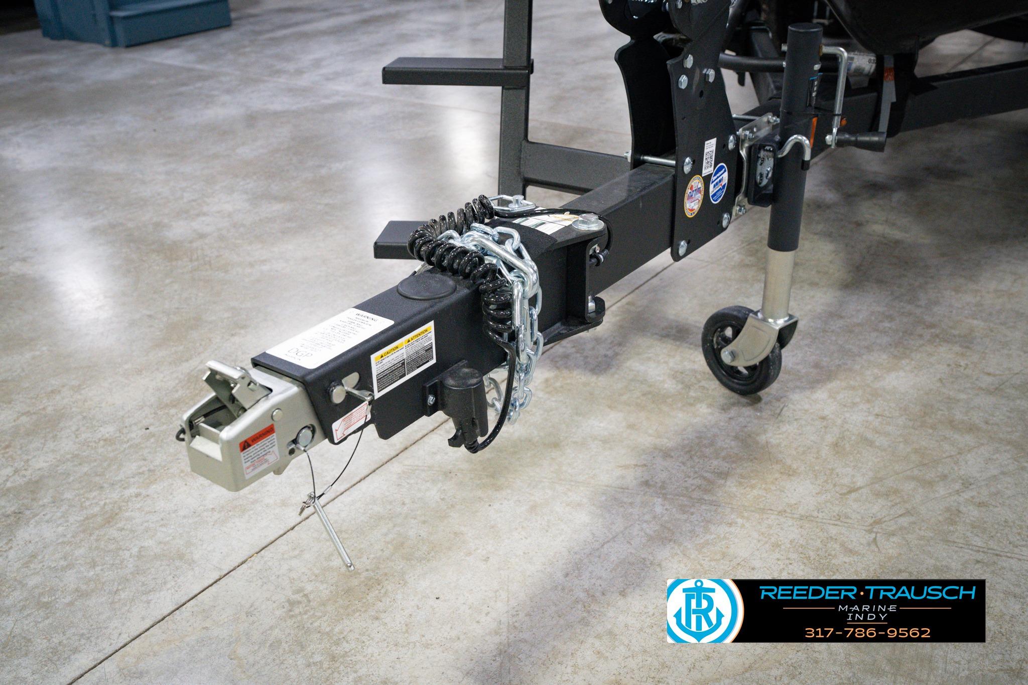 Trailer hitch of 2026 Lund 1875 Impact XS SS boat, featuring safety chains and wheel jack.