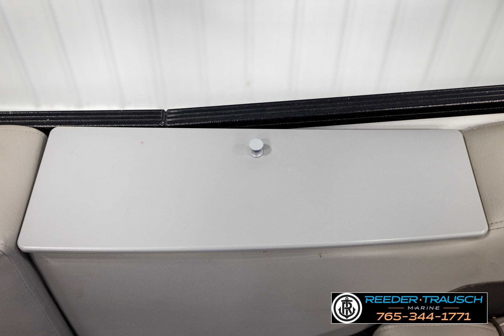 2019 Manitou Oasis SR VP boat interior detail with storage compartment and Reeder Trausch Marine logo.