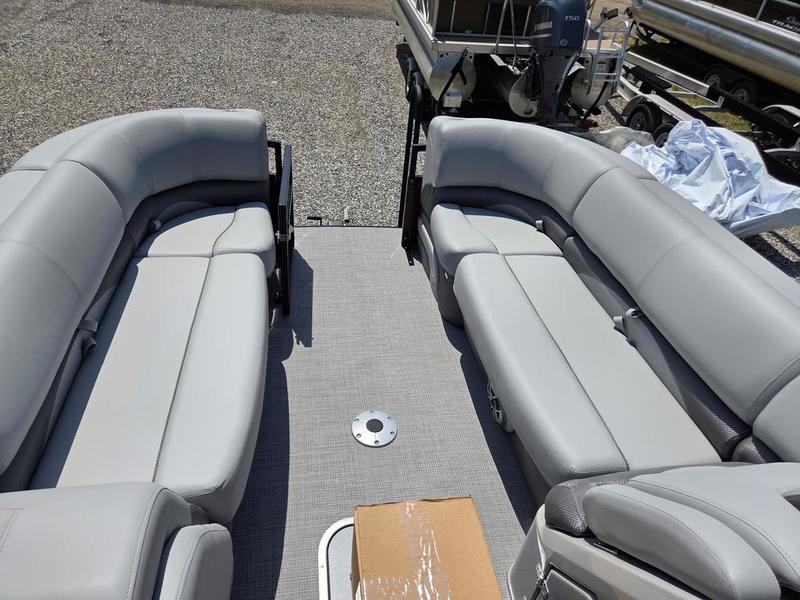 2025 Regency 230 DL3 pontoon boat interior with gray seating and carpeted deck.