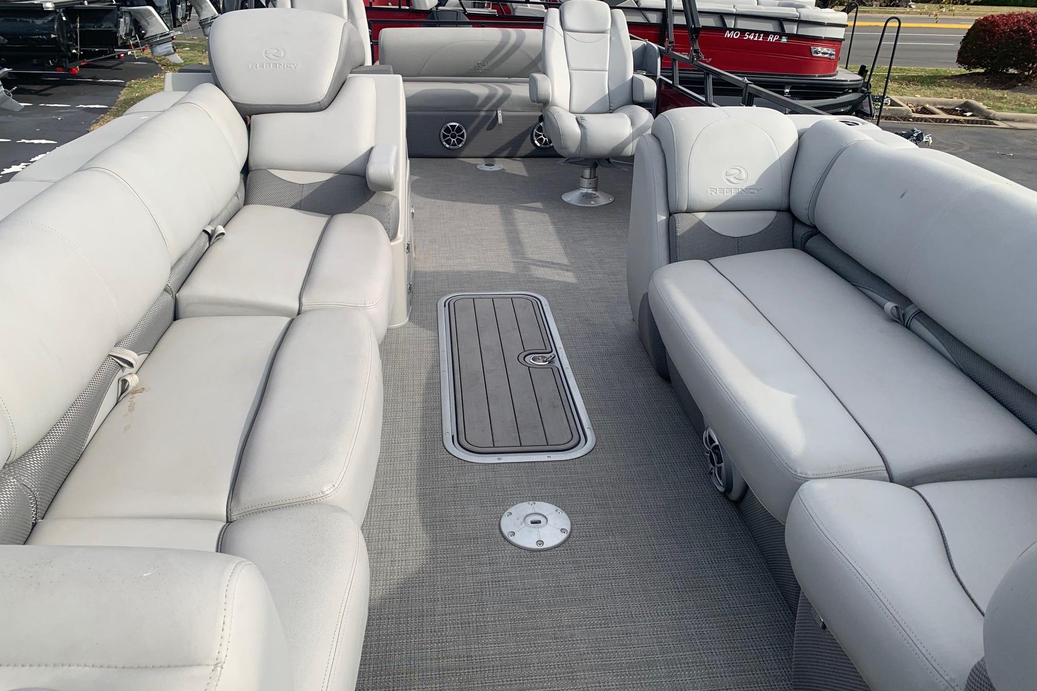 2024 Regency 250DL3 pontoon boat interior with plush gray seating and spacious layout.