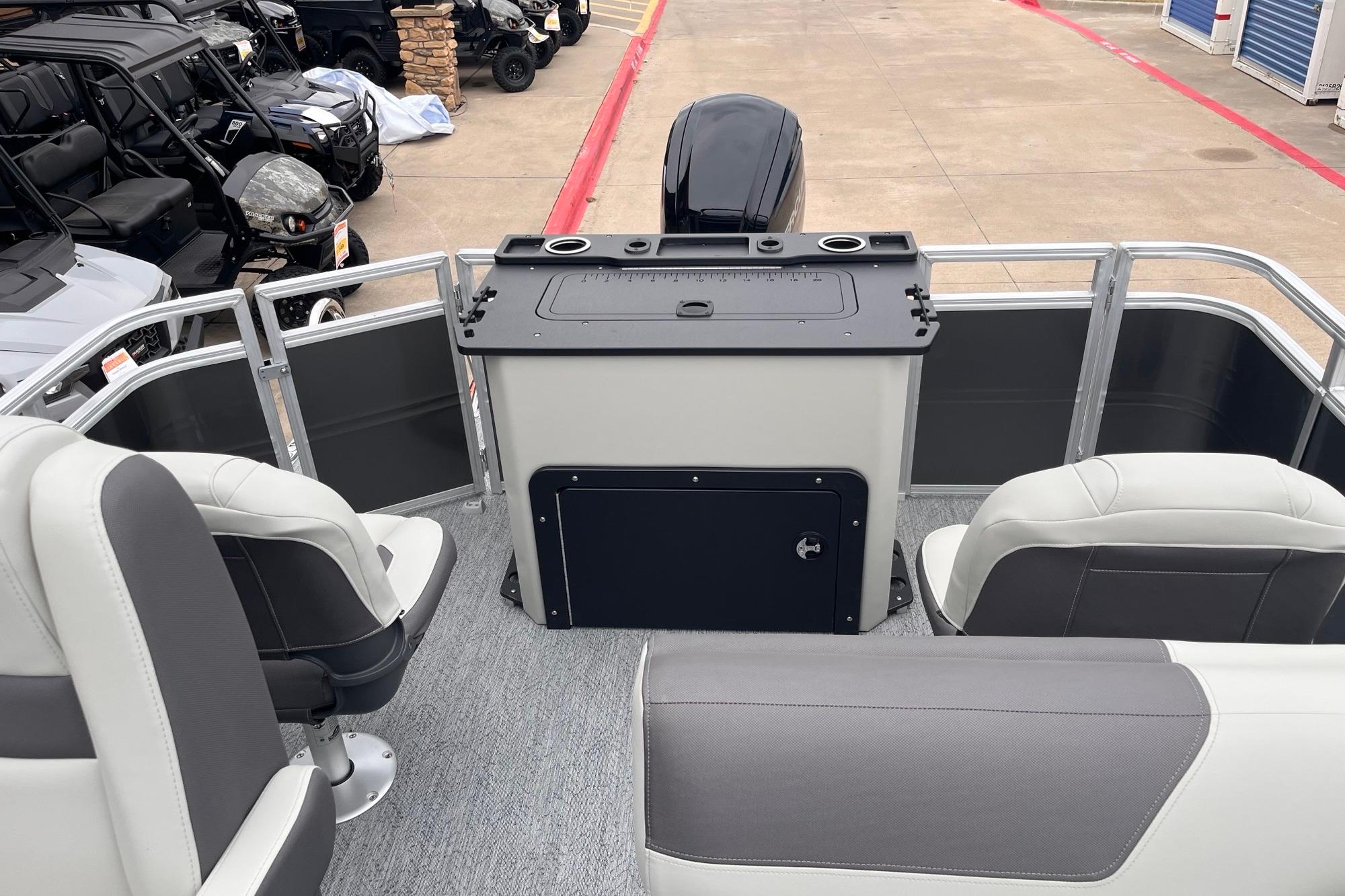 2026 Sun Tracker Fishin' Barge 20 DLX interior with seating and control panel.