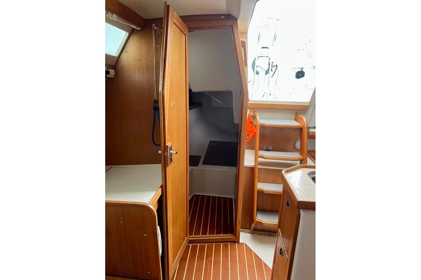 Interior of 1998 Catalina 36 MkII sailboat with wooden cabinetry and steps.