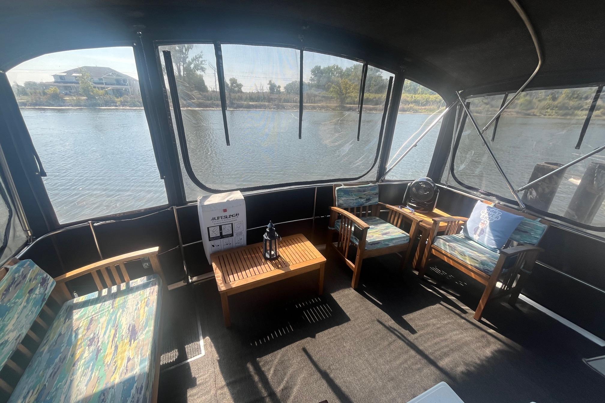 Interior of 1990 Cooper Prowler 35 boat with seating and river view.