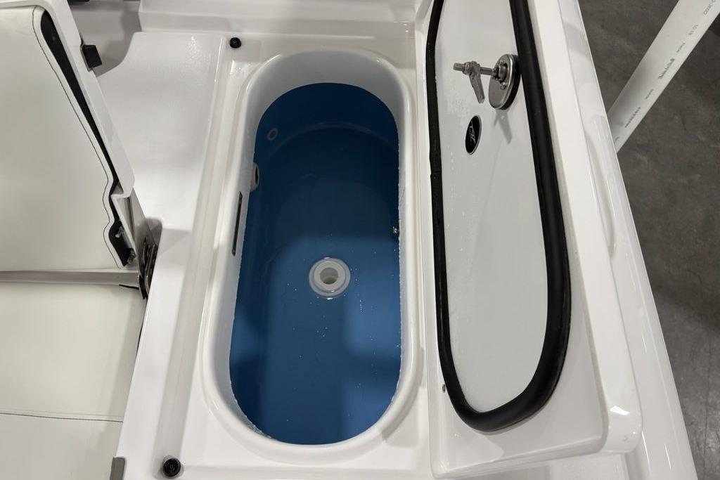 Livewell compartment on 2026 Tidewater 2210 Carolina Bay boat, featuring a blue interior.