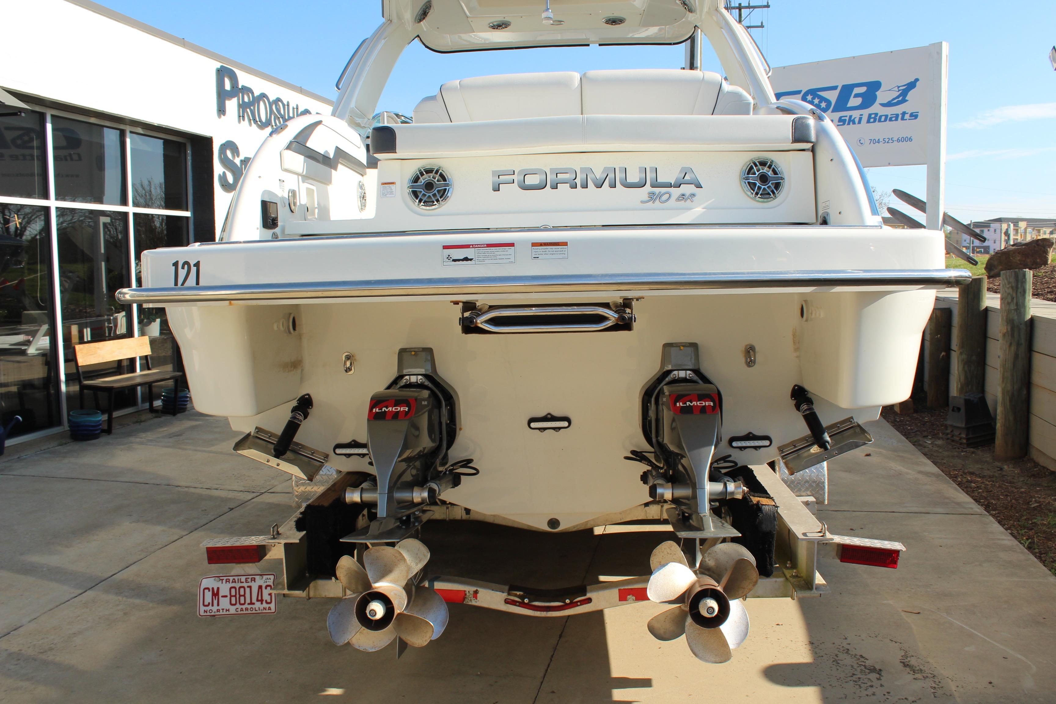 2023 Formula 310 Bowrider I/O boat rear view with dual propellers and sleek design.
