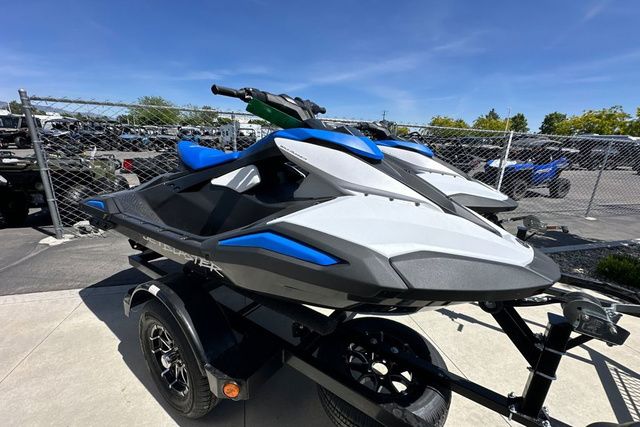 A Yamaha WaveRunner Jetblaster in black sits on a trailer in a fenced area.