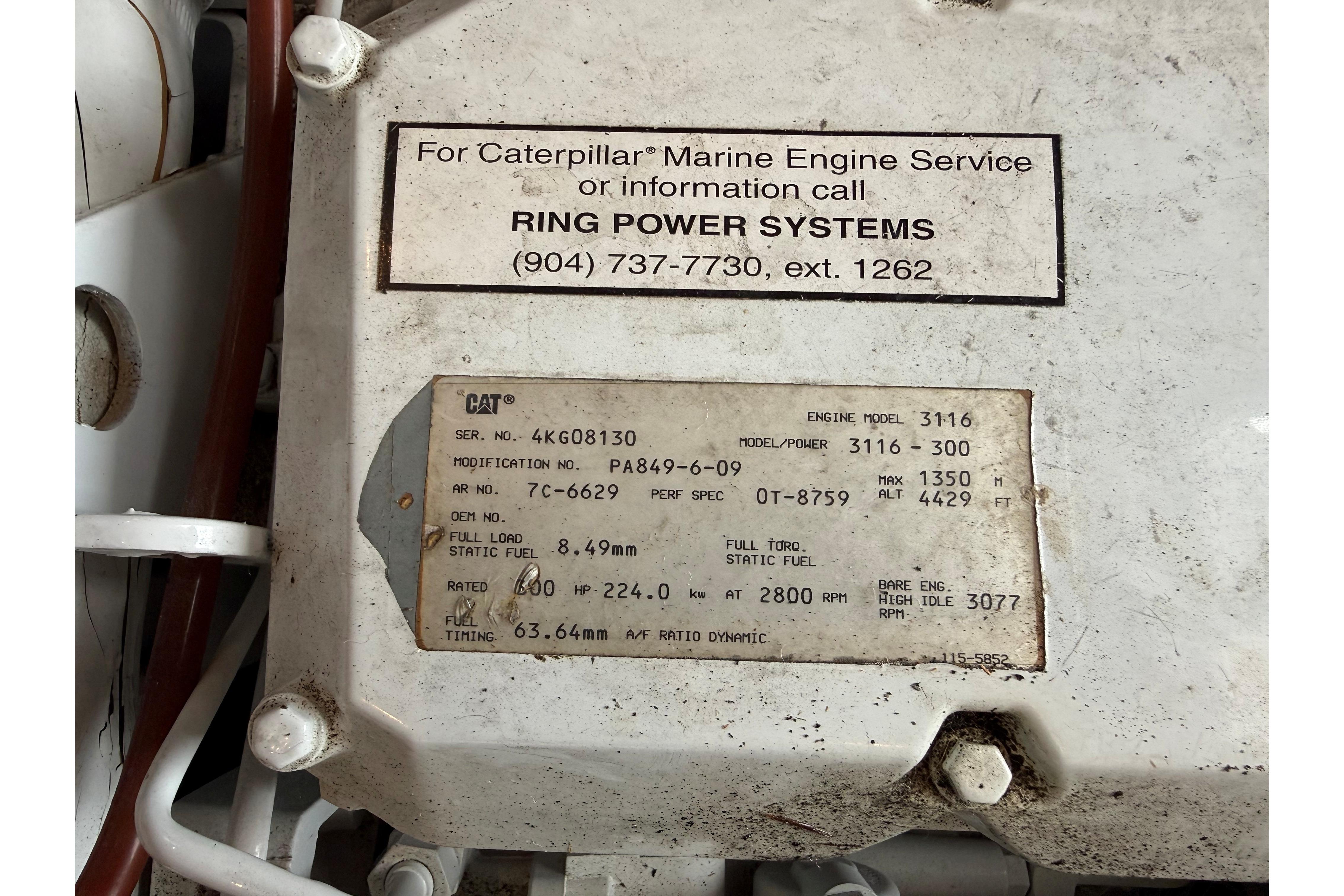Caterpillar marine engine label on 1999 Mainship 350 Trawler, model 3116, with service contact details.