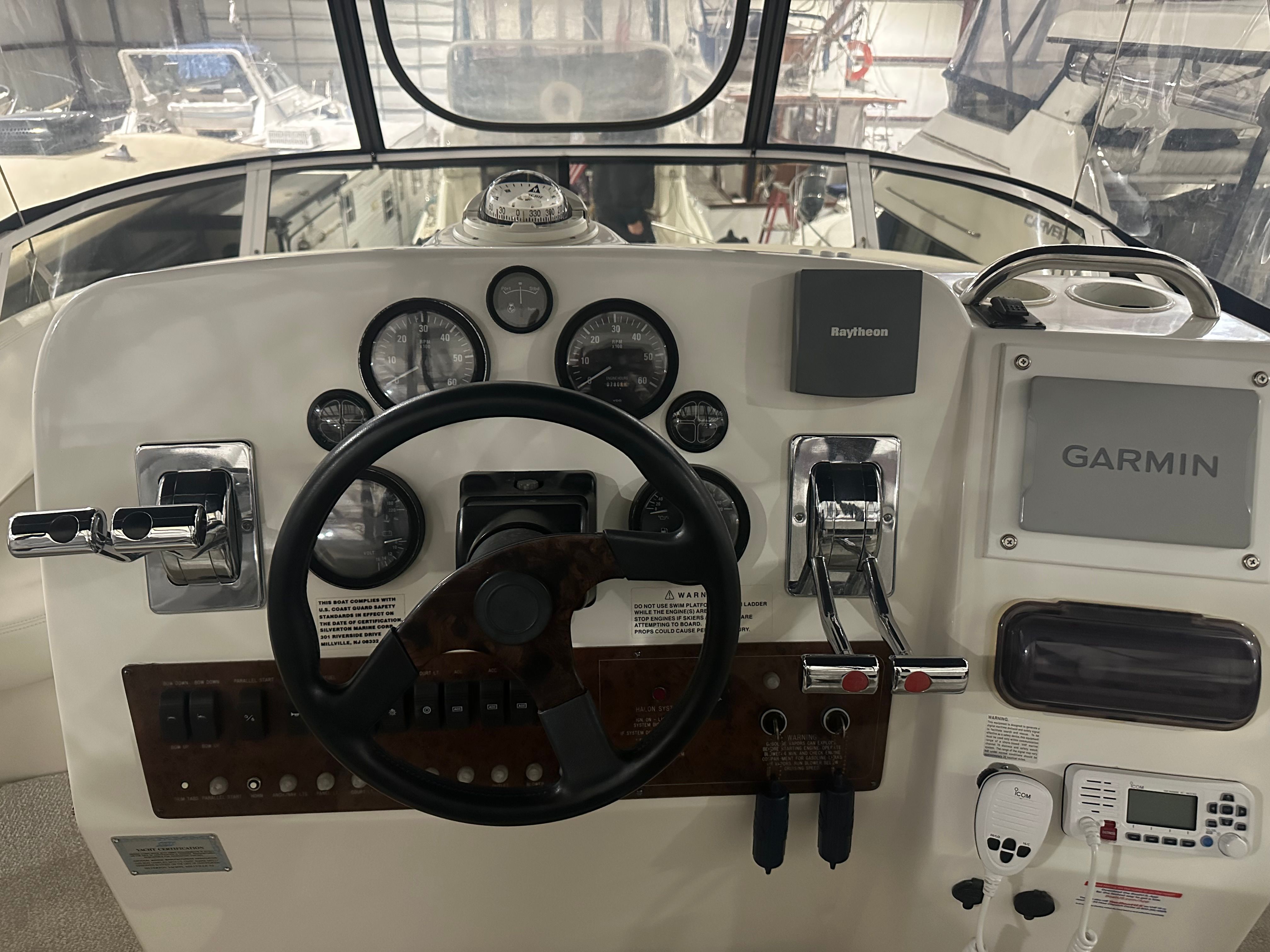 Helm of a 2000 Silverton 351 Sedan with Garmin and Raytheon equipment.