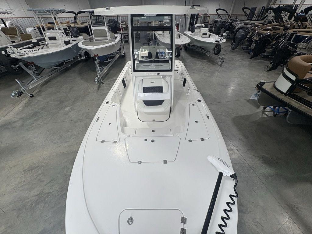 2026 Tidewater 2110 BM boat in showroom, surrounded by other boats.