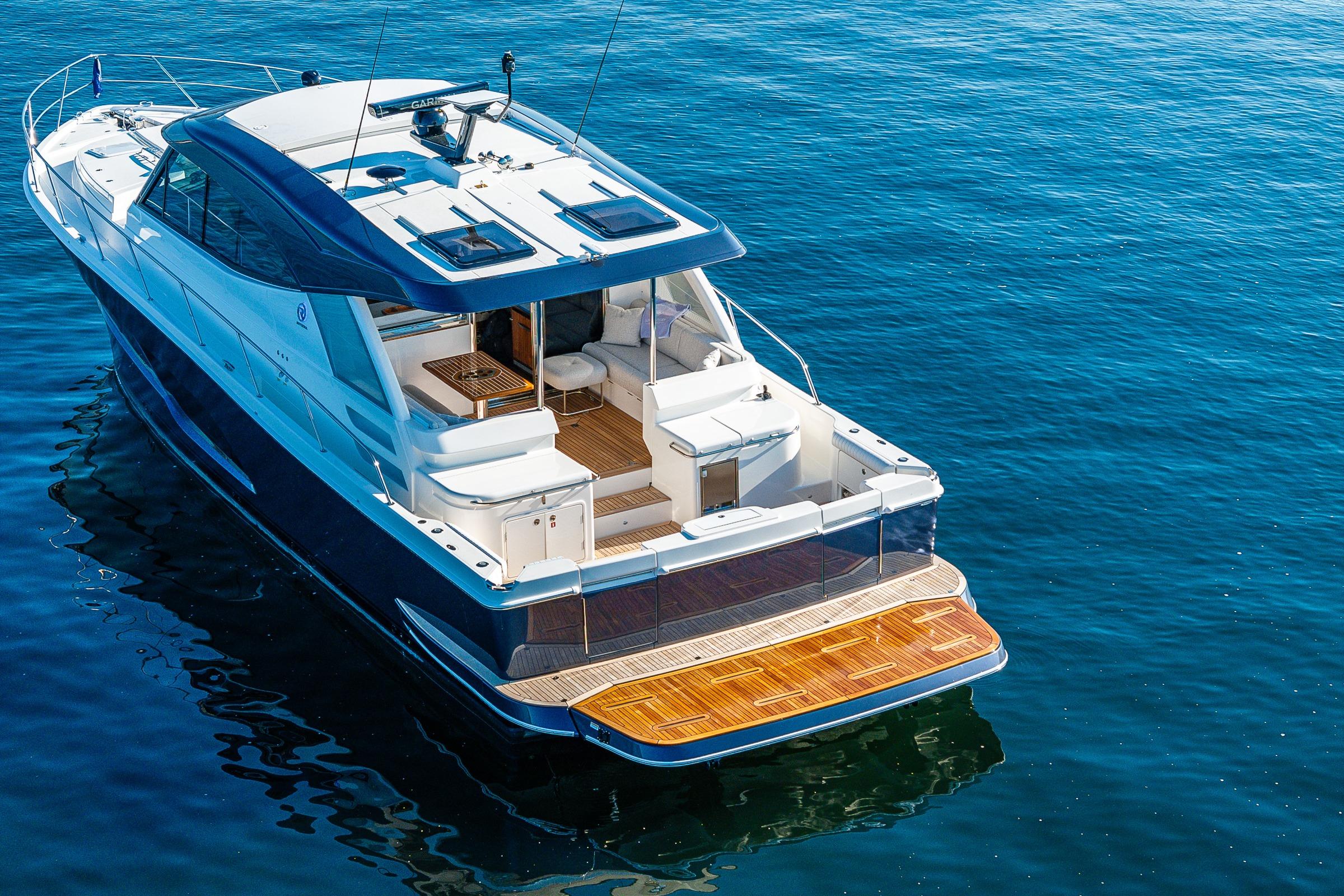 2026 Riviera 505 SUV luxury yacht on calm blue water, showcasing sleek design and spacious deck.