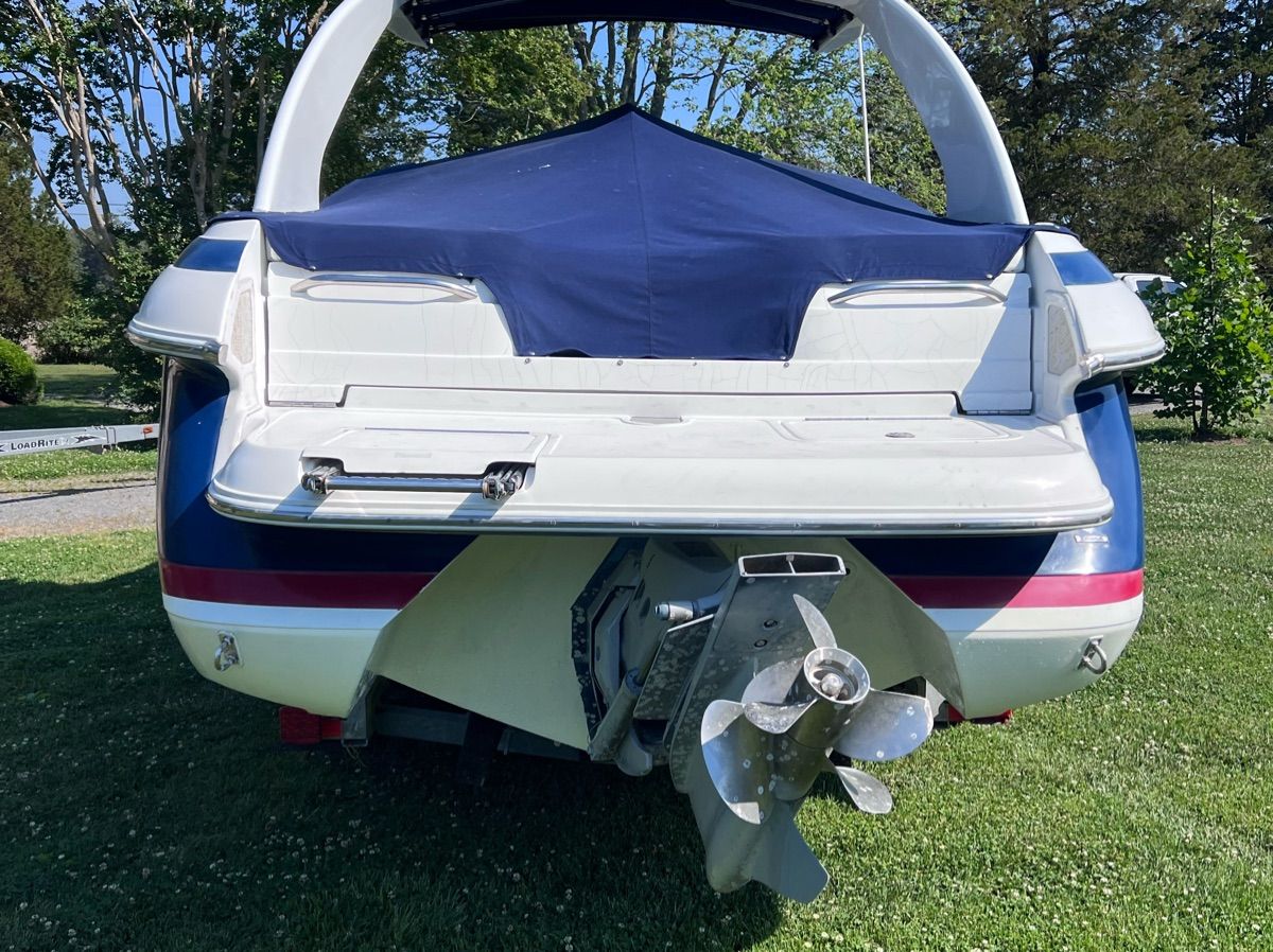 Rear view of a 2003 Cobalt Colbalt 262 boat on grass.