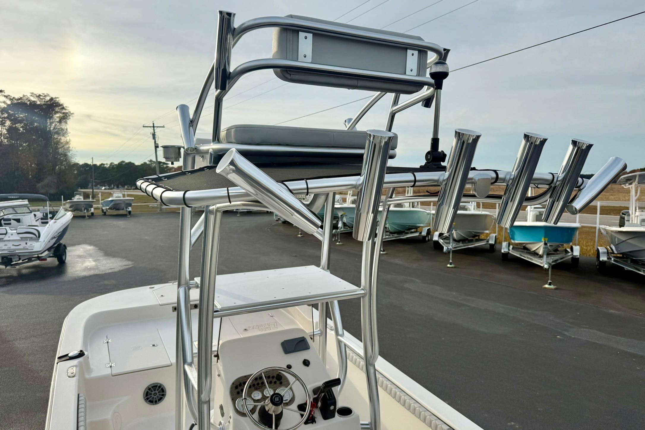 2025 Carolina Skiff 21 LS boat with elevated seating and rod holders in a marina.