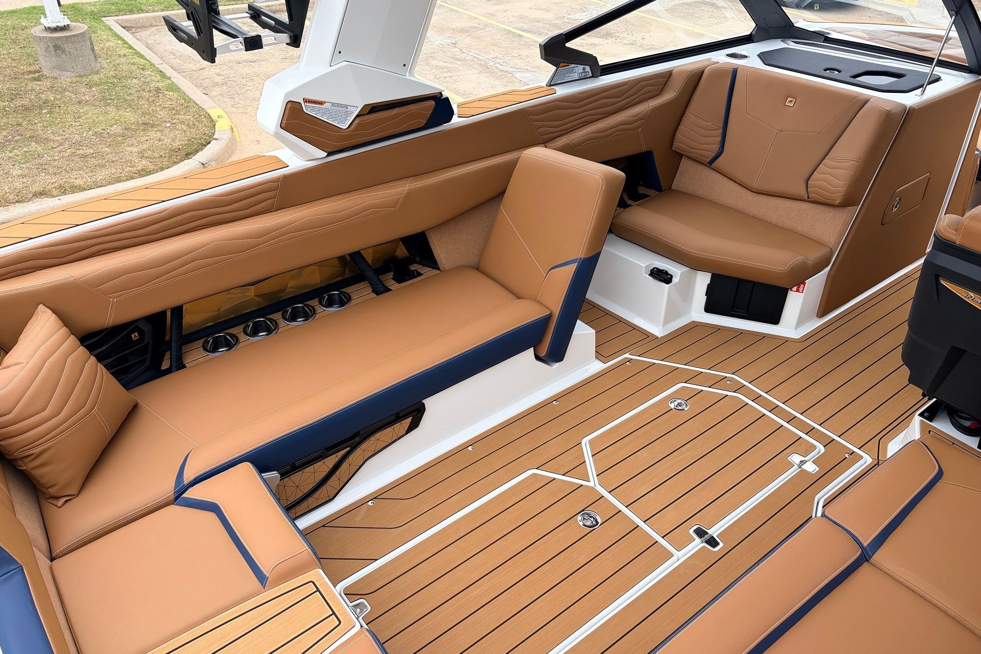 2026 Nautique Super Air Nautique G25 interior with tan leather seating and teak flooring.