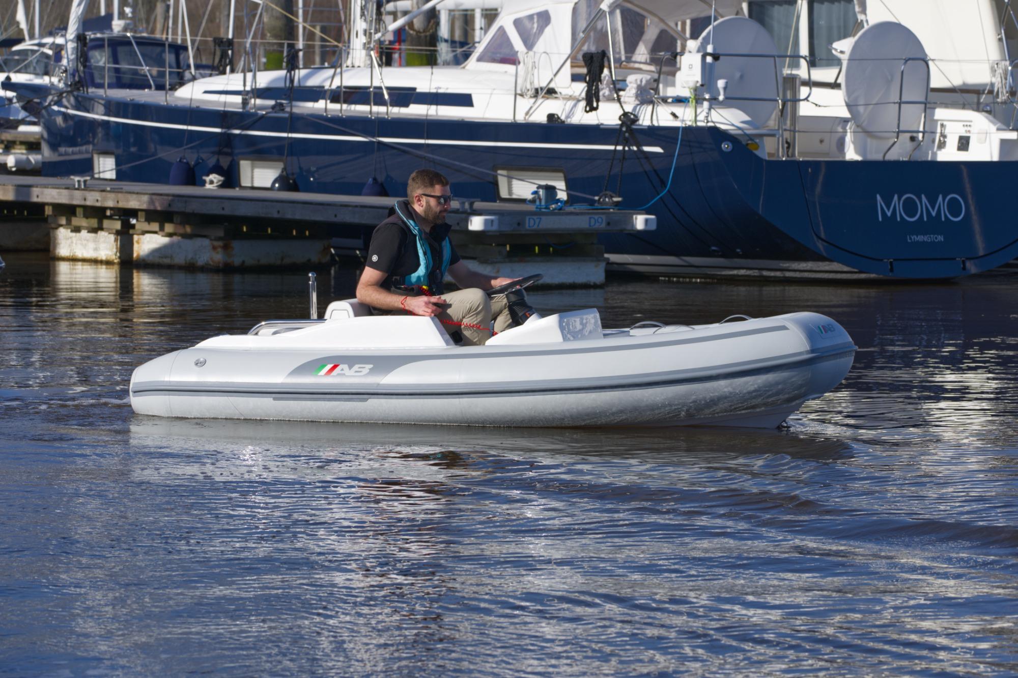 2023 AB Inflatables 350 XP boat on water near marina.