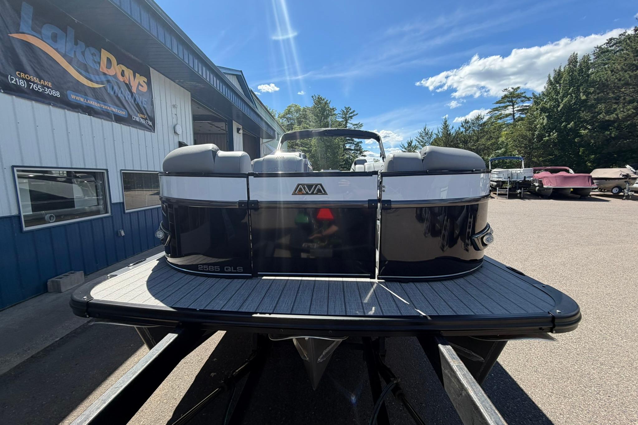 2026 Avalon Catalina Quad Lounge Shift pontoon boat at dealership, sunny day.