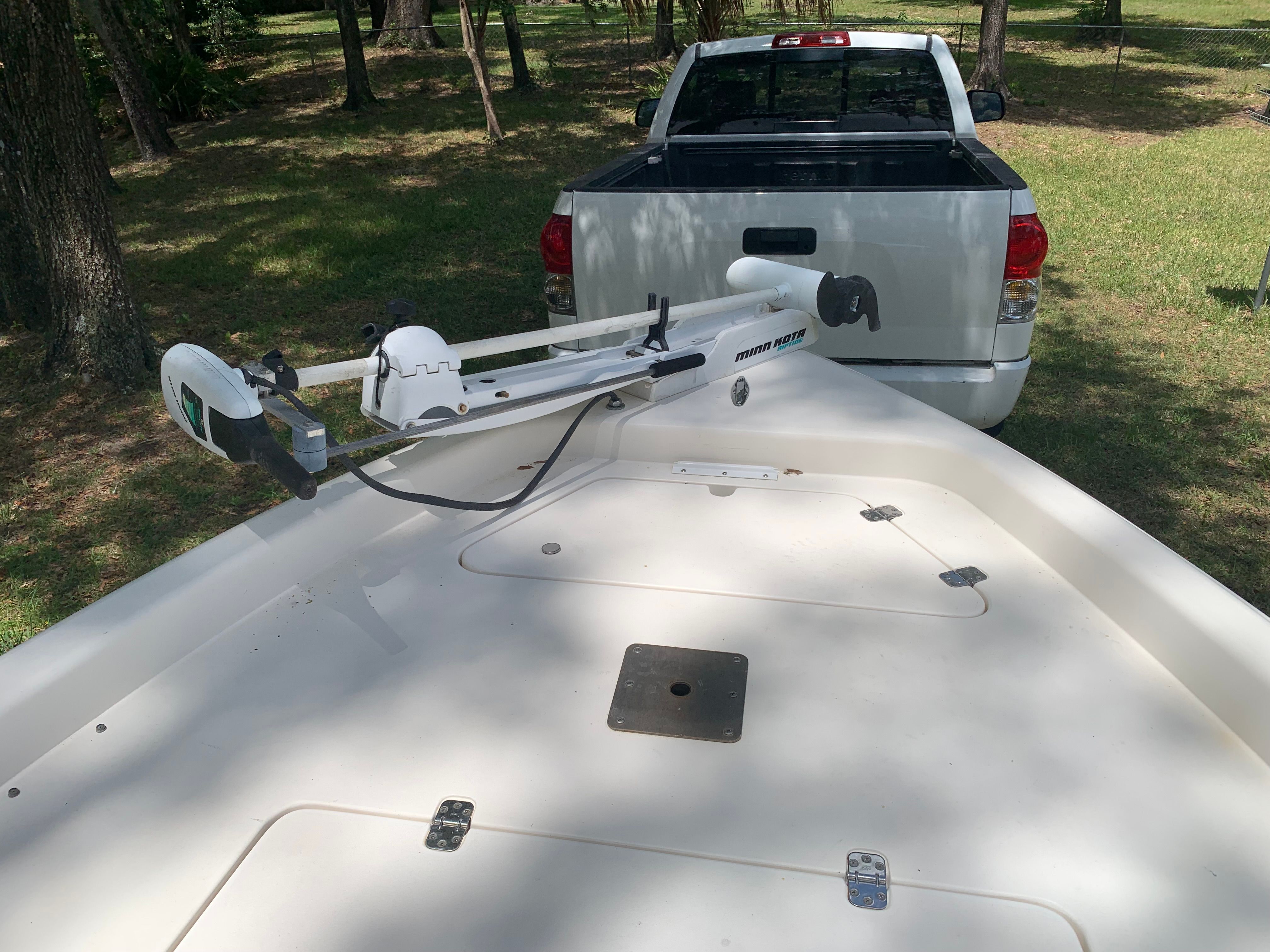 ShearWater 23 LTZ 2007 boat with Minn Kota motor, parked in front of white truck.