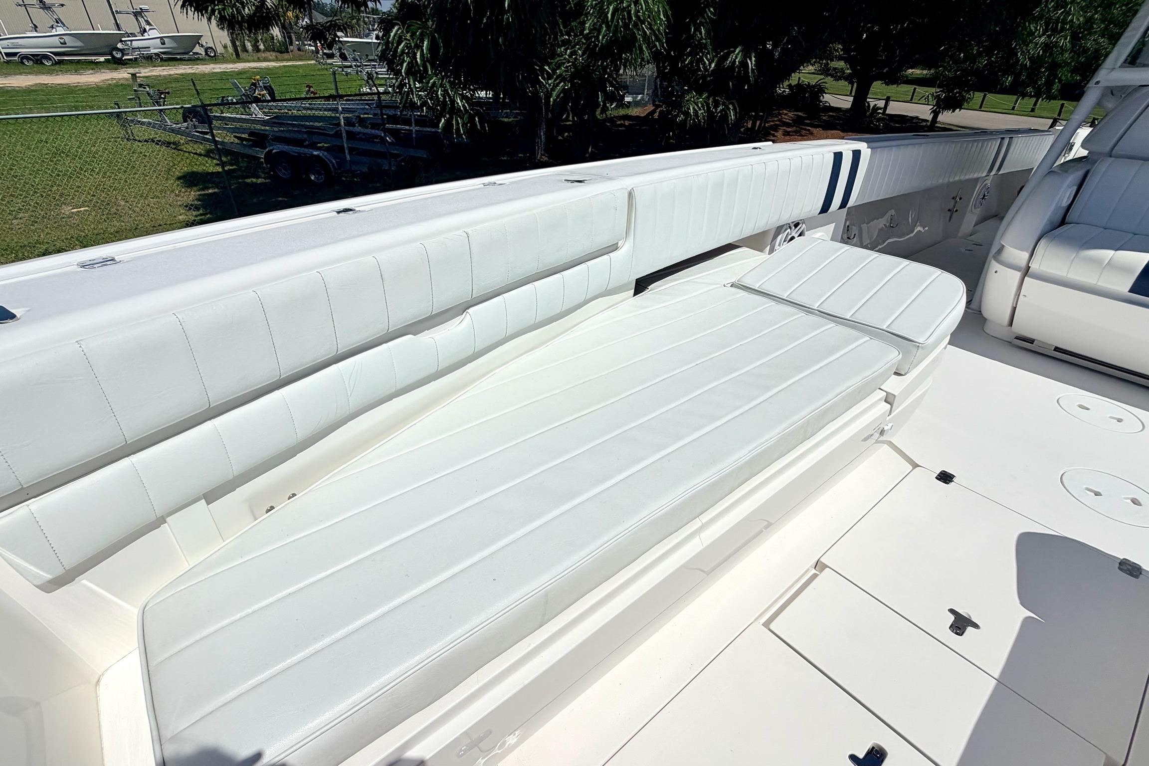 2005 Intrepid 370 Center Console boat with white cushioned seating and spacious deck.