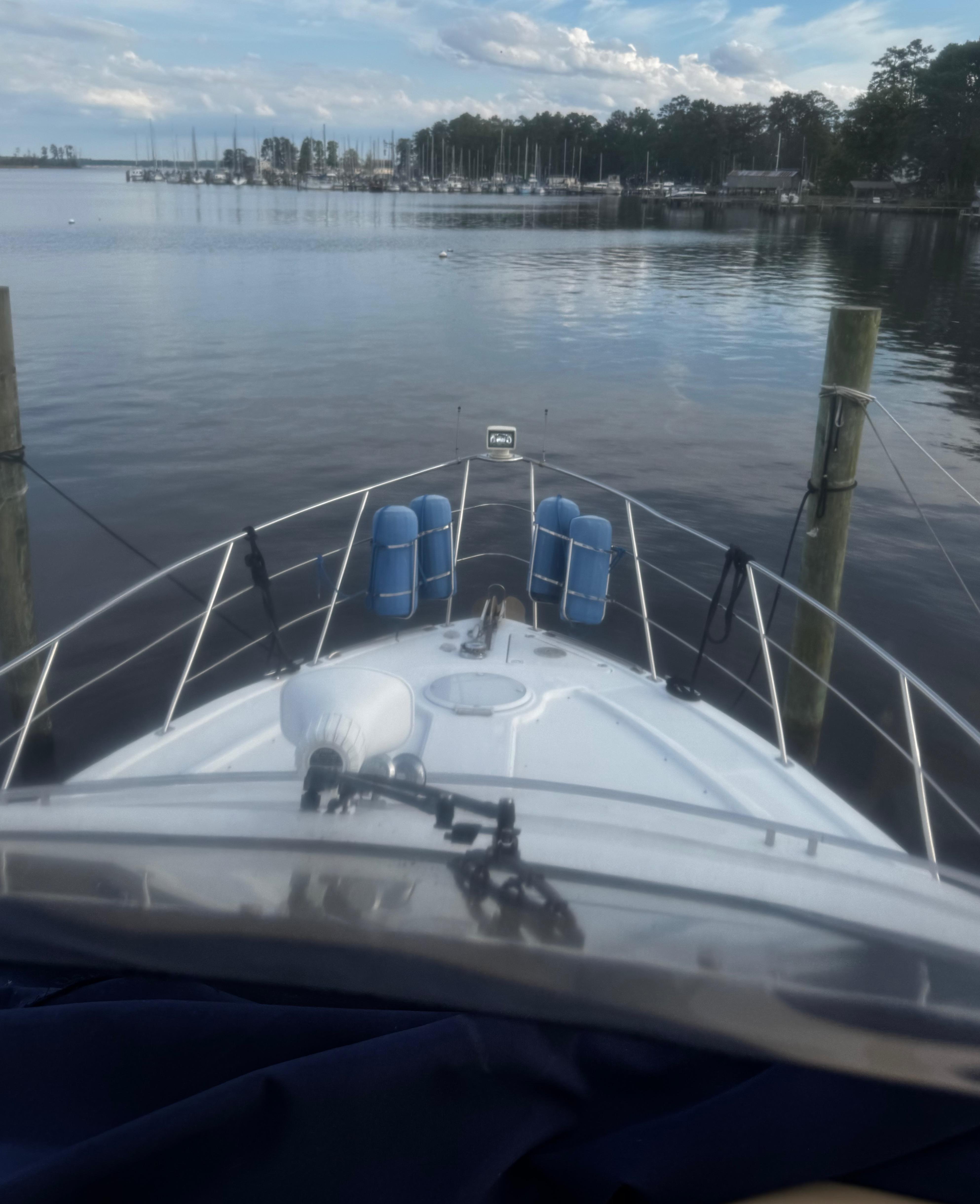 Bow view of 2001 Carver 466 Motor Yacht docked at a serene marina.