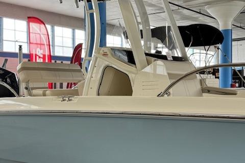 2025 Boston Whaler 220 Dauntless boat displayed indoors.