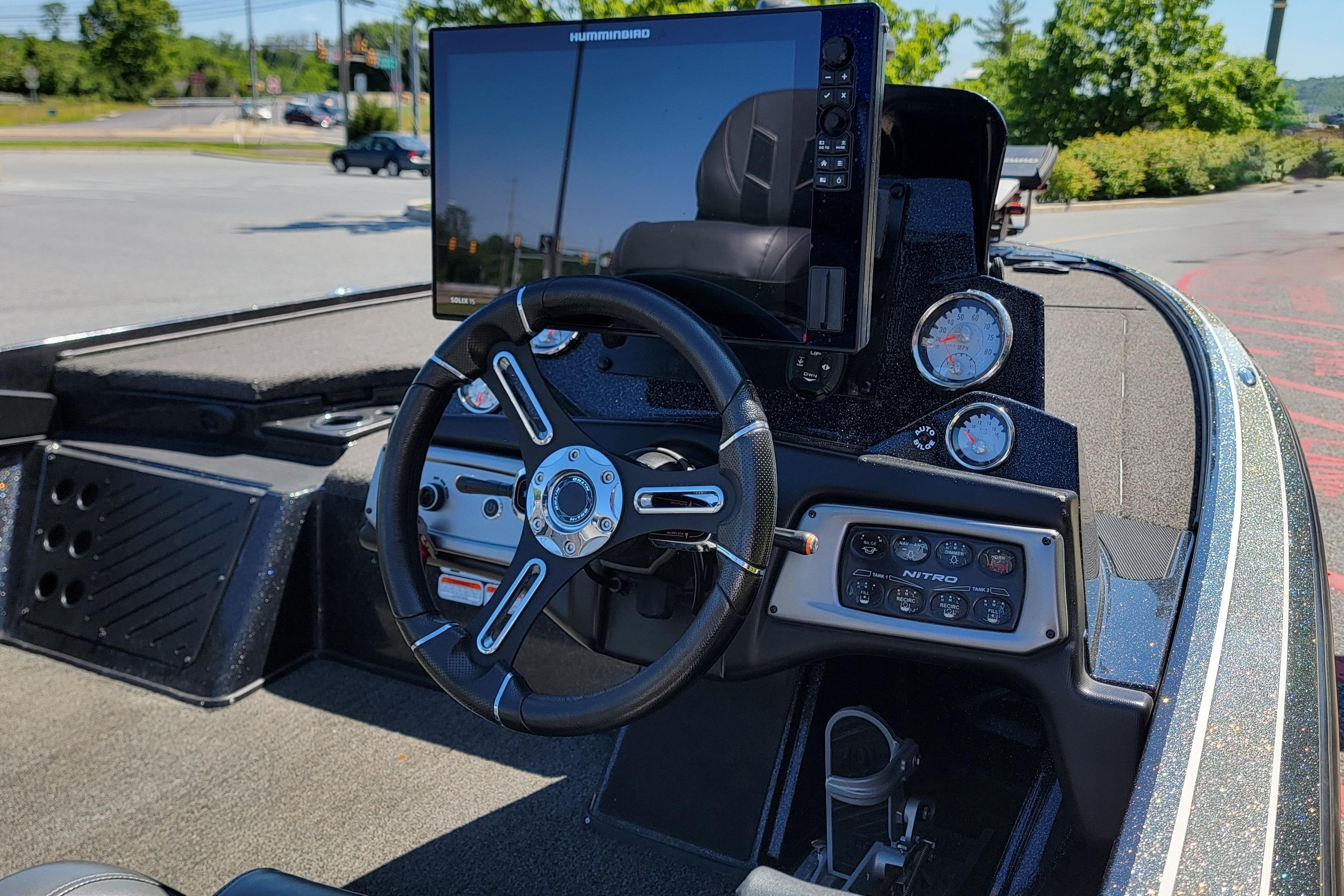 Dashboard of a 2020 Nitro Z19 Pro boat with steering wheel and electronic display.