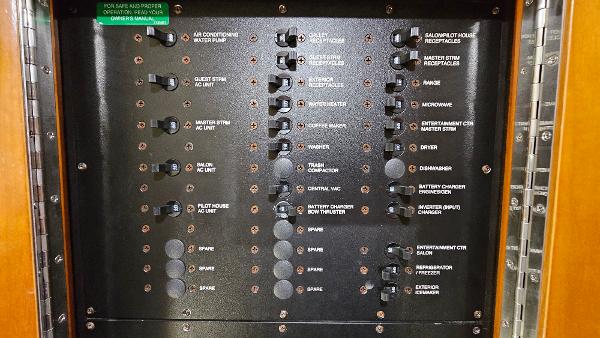 Electrical panel of 2000 Carver 450 Voyager Pilothouse with labeled switches and controls.