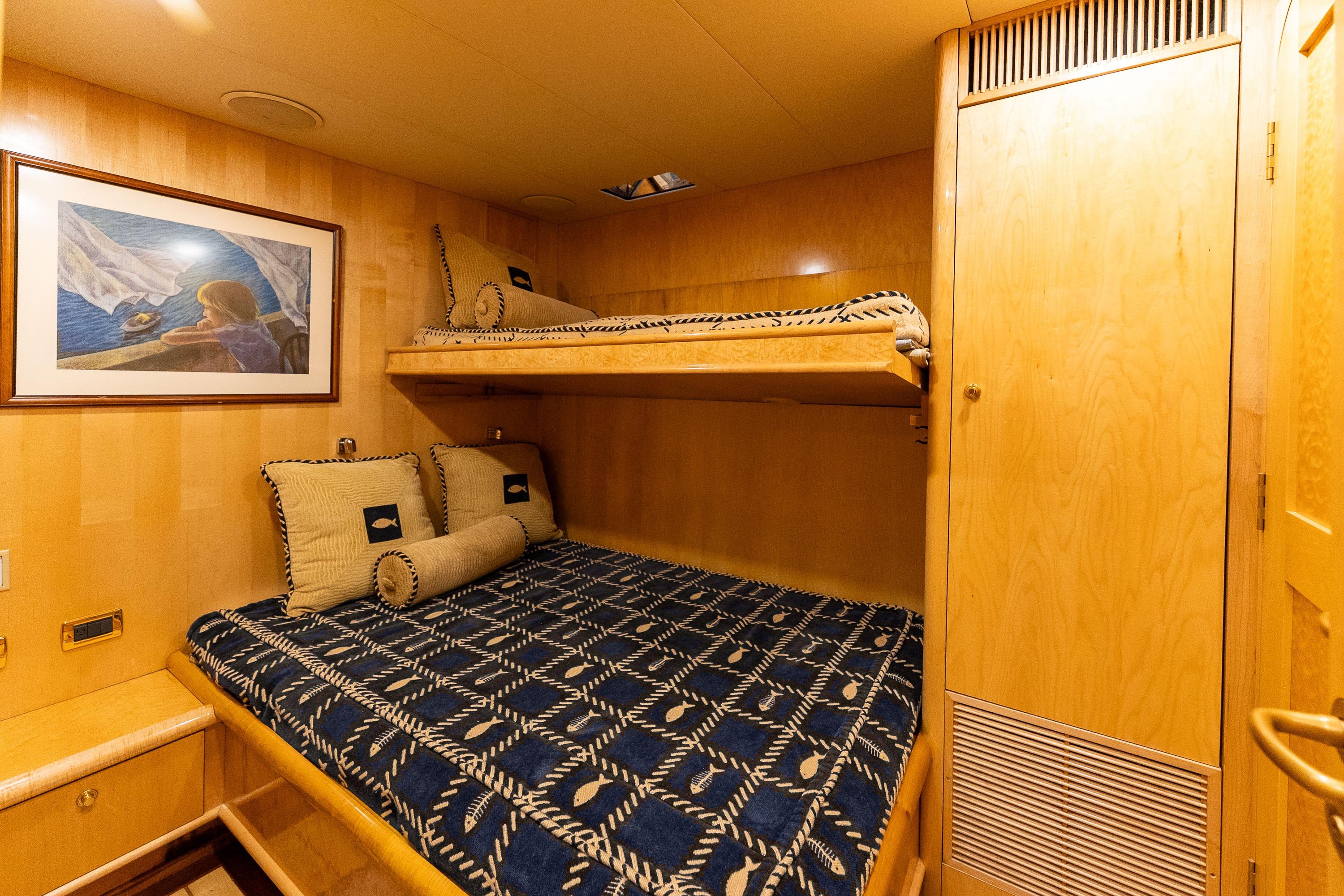 Cozy cabin interior of 1985 Delta Marine Expedition Yacht with bunk beds and nautical decor.