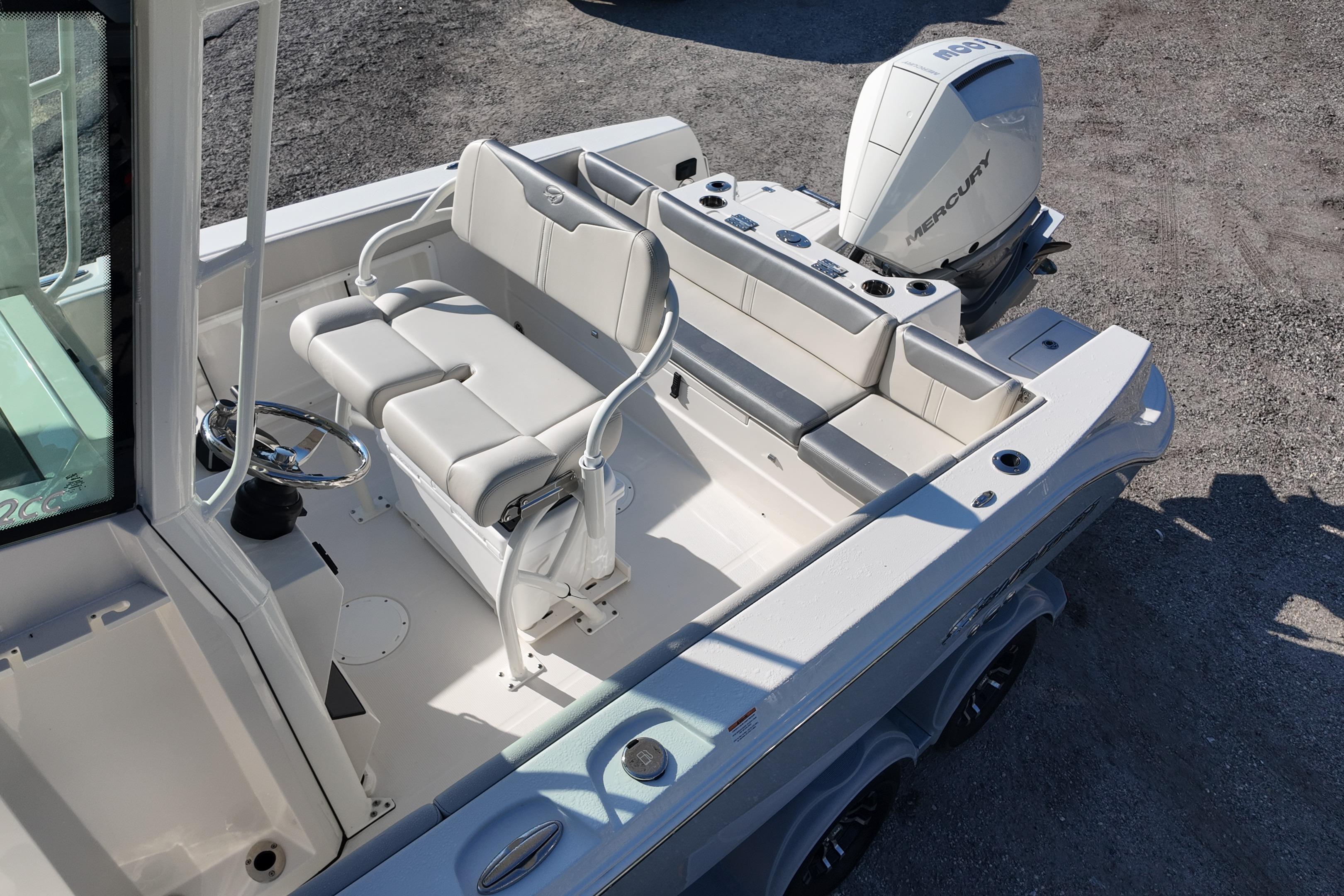 2026 Sailfish 232 CC boat interior with seating and Mercury outboard engine.