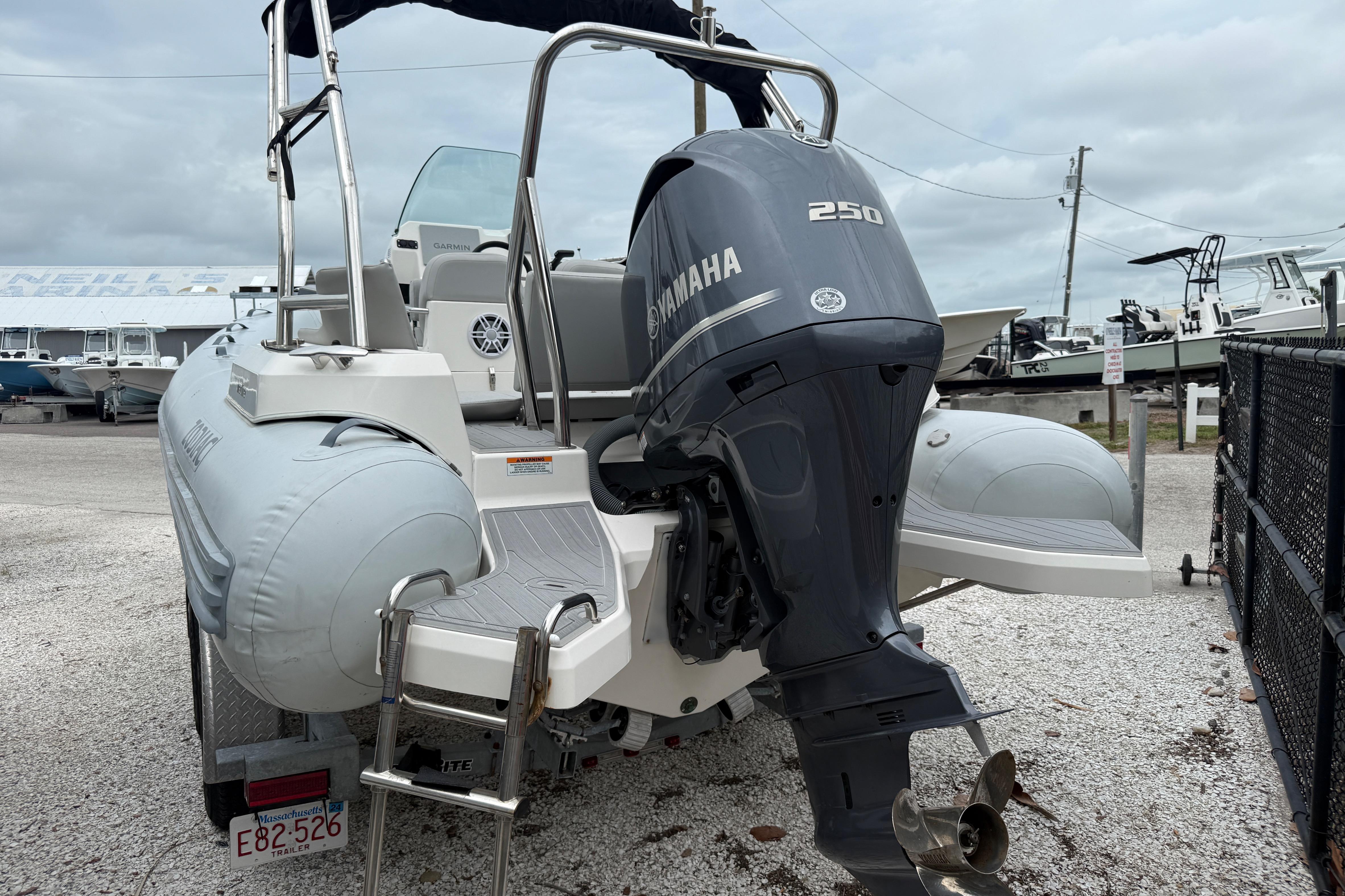 2023 Zodiac Medline 6.8 boat with Yamaha 250 engine, parked on gravel.