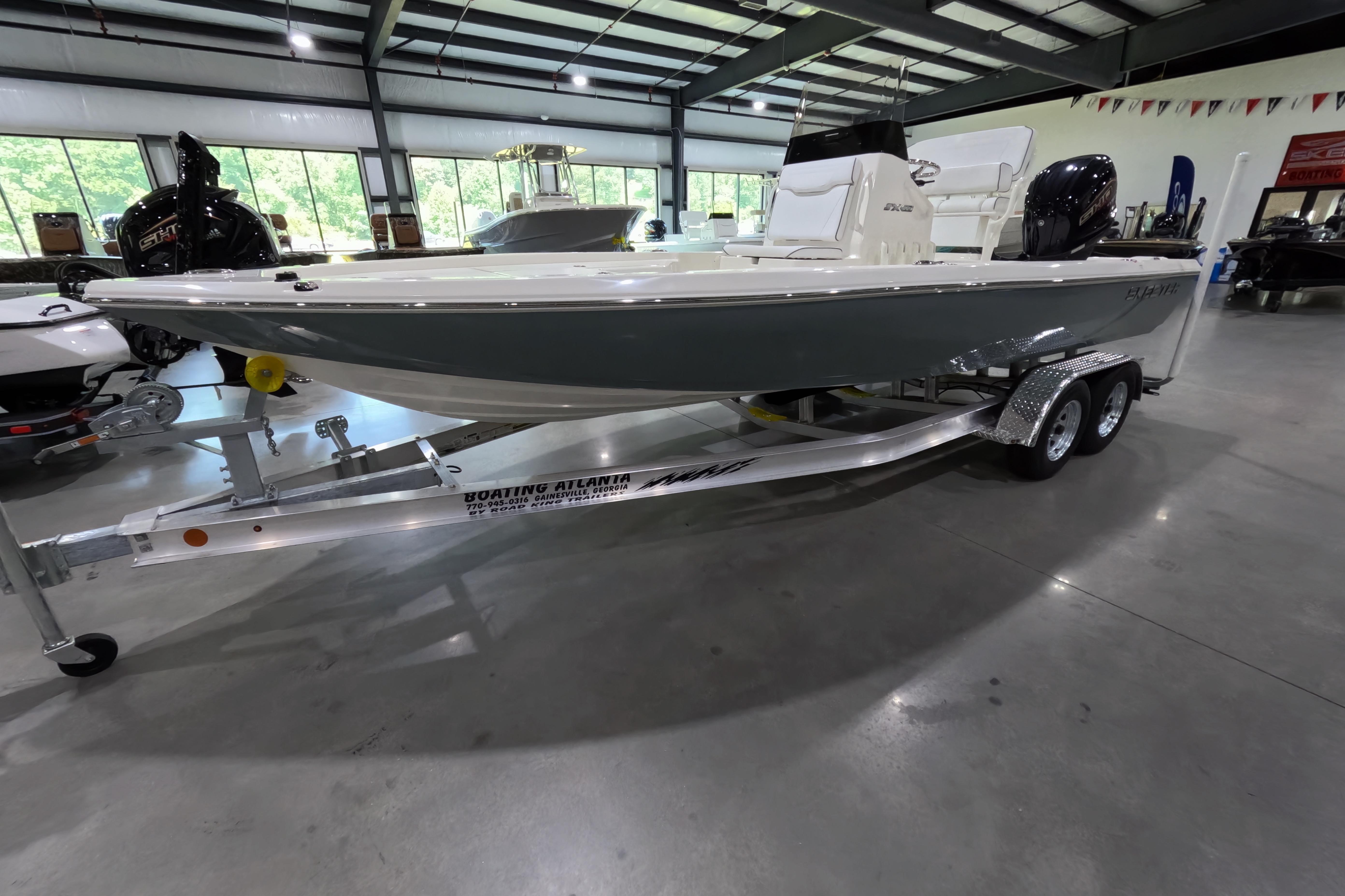 2026 Skeeter boat on trailer in showroom, featuring sleek design and modern outboard motor.